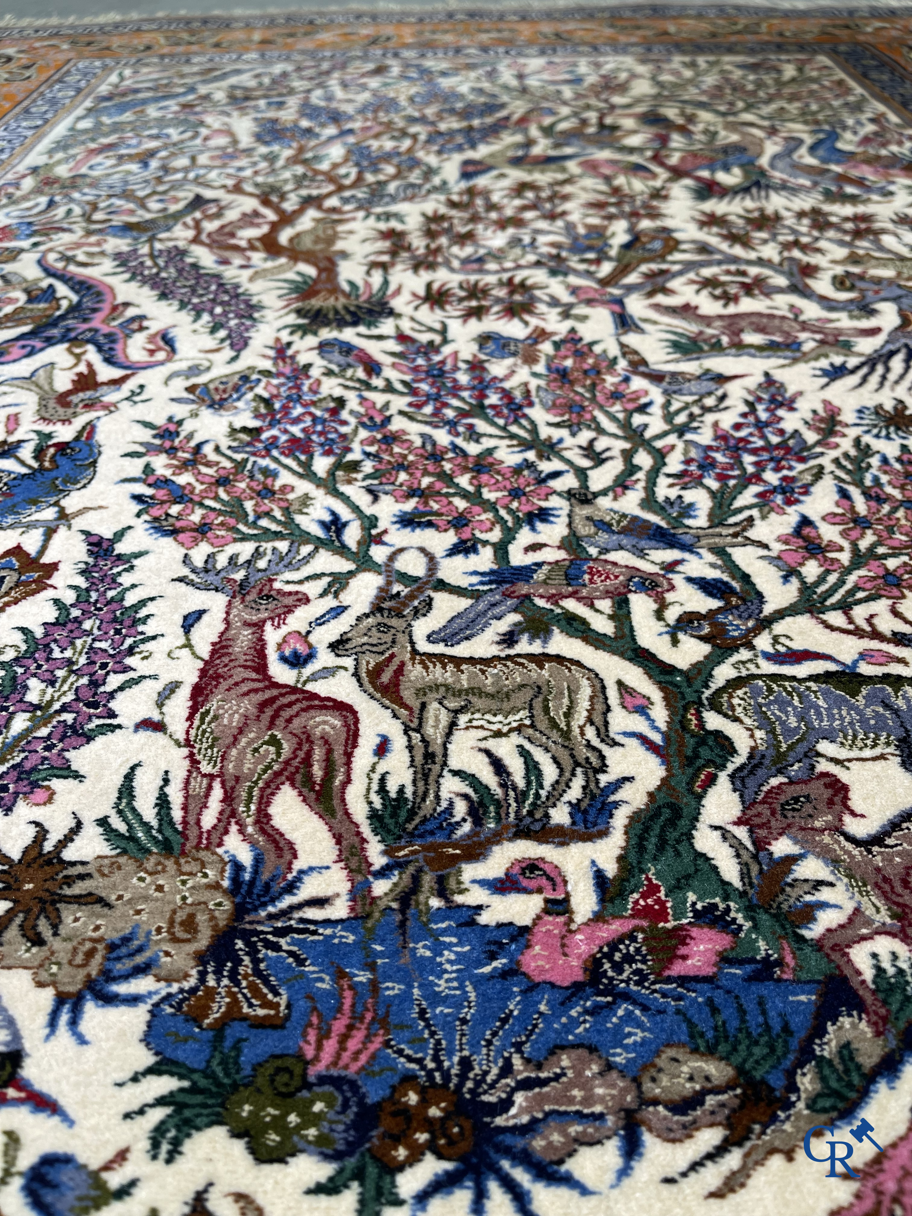 Oriental carpets, a finely hand-knotted silk carpet with forest animals. Signed.