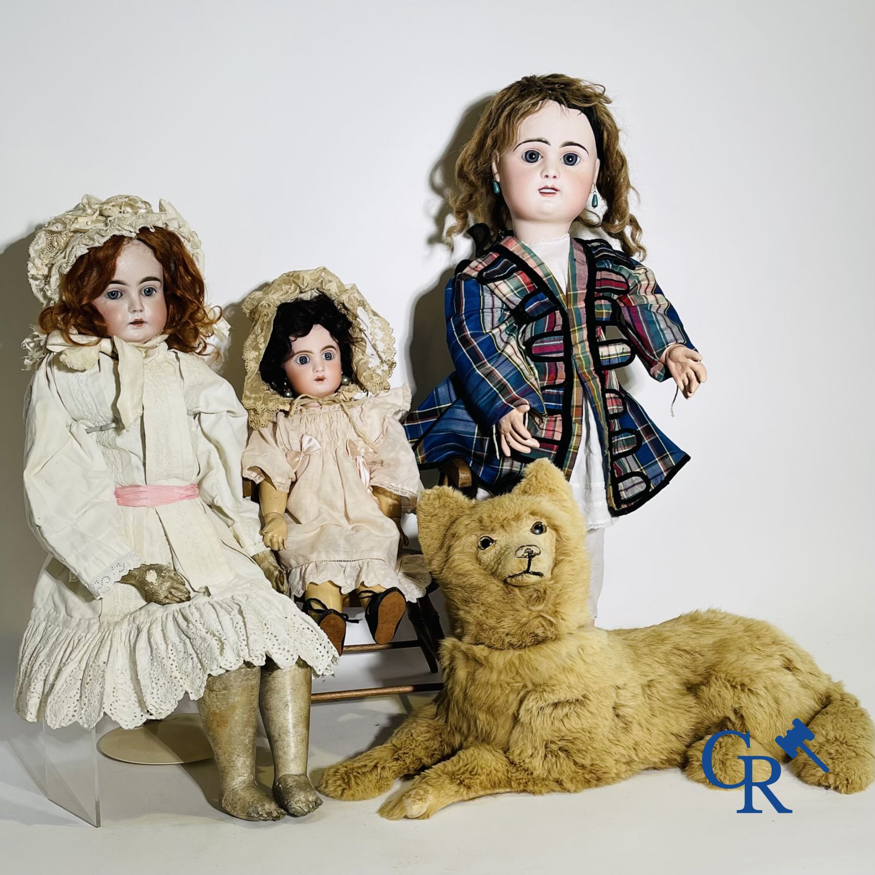 Toys: antique dolls. 3 dolls with porcelain head and a dog in fur.