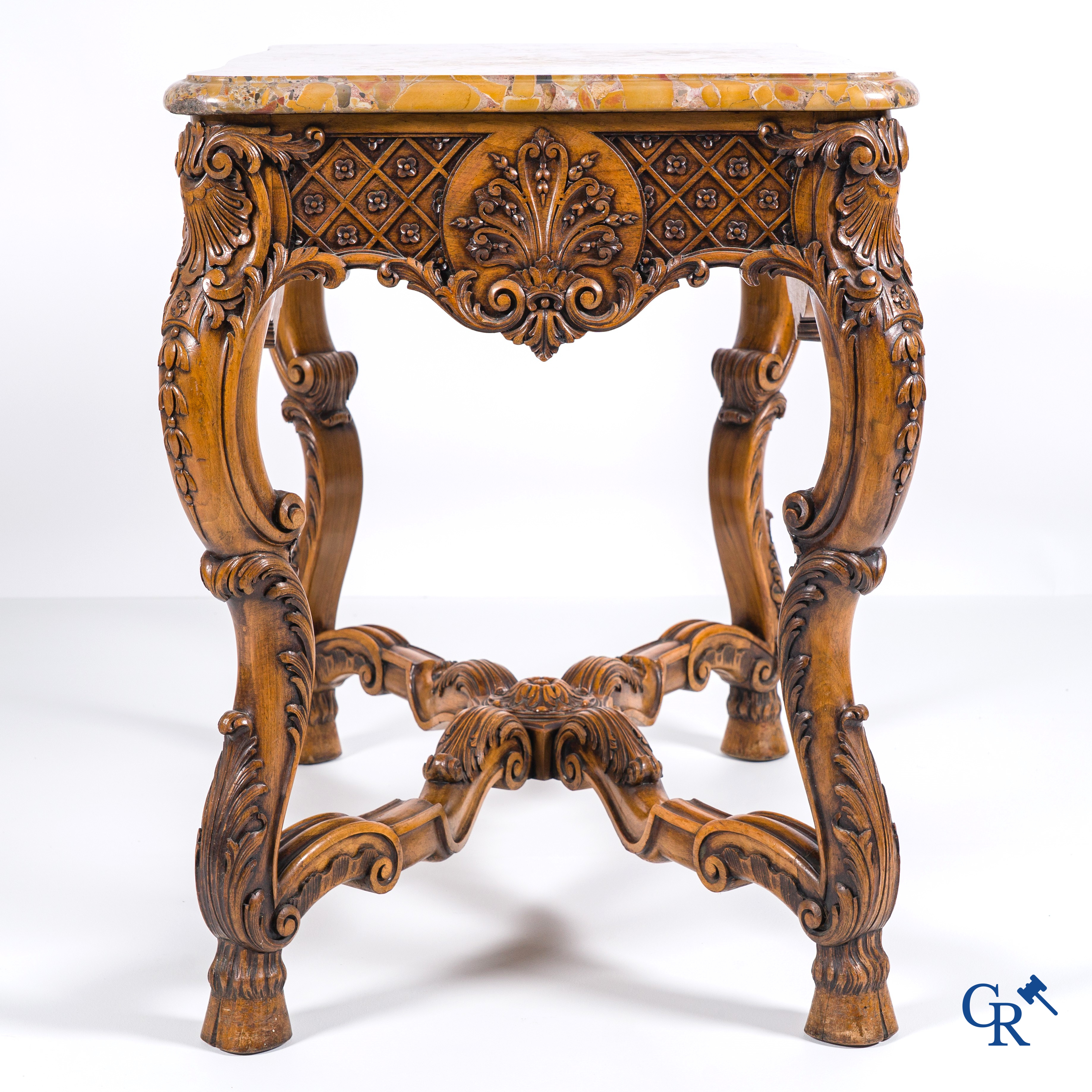 A richly carved wooden console table with a marble top. Circa 1930.