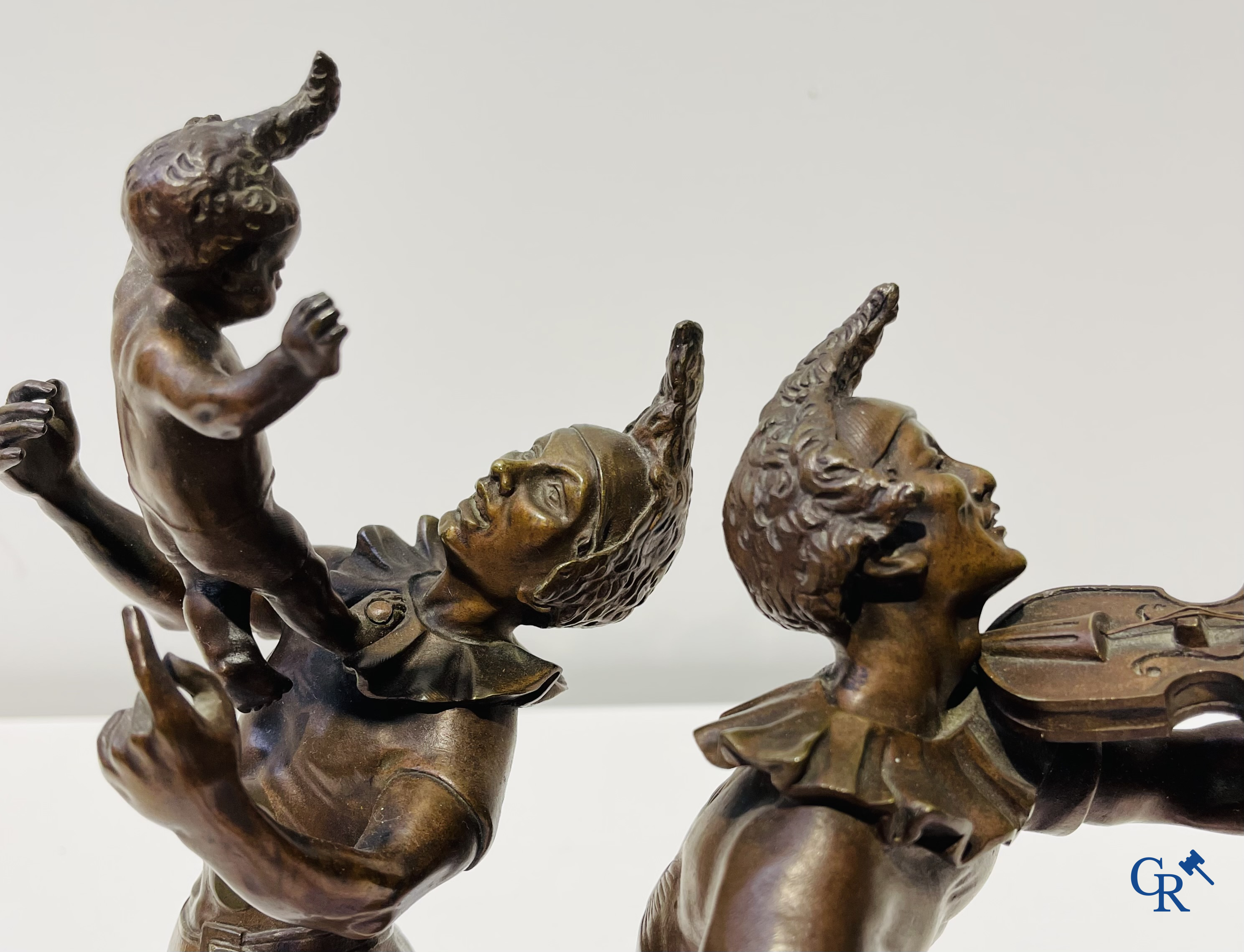 Auguste de Wever (1836-1910) Pair of bronze statues, harlequin with child and music playing harlequin.