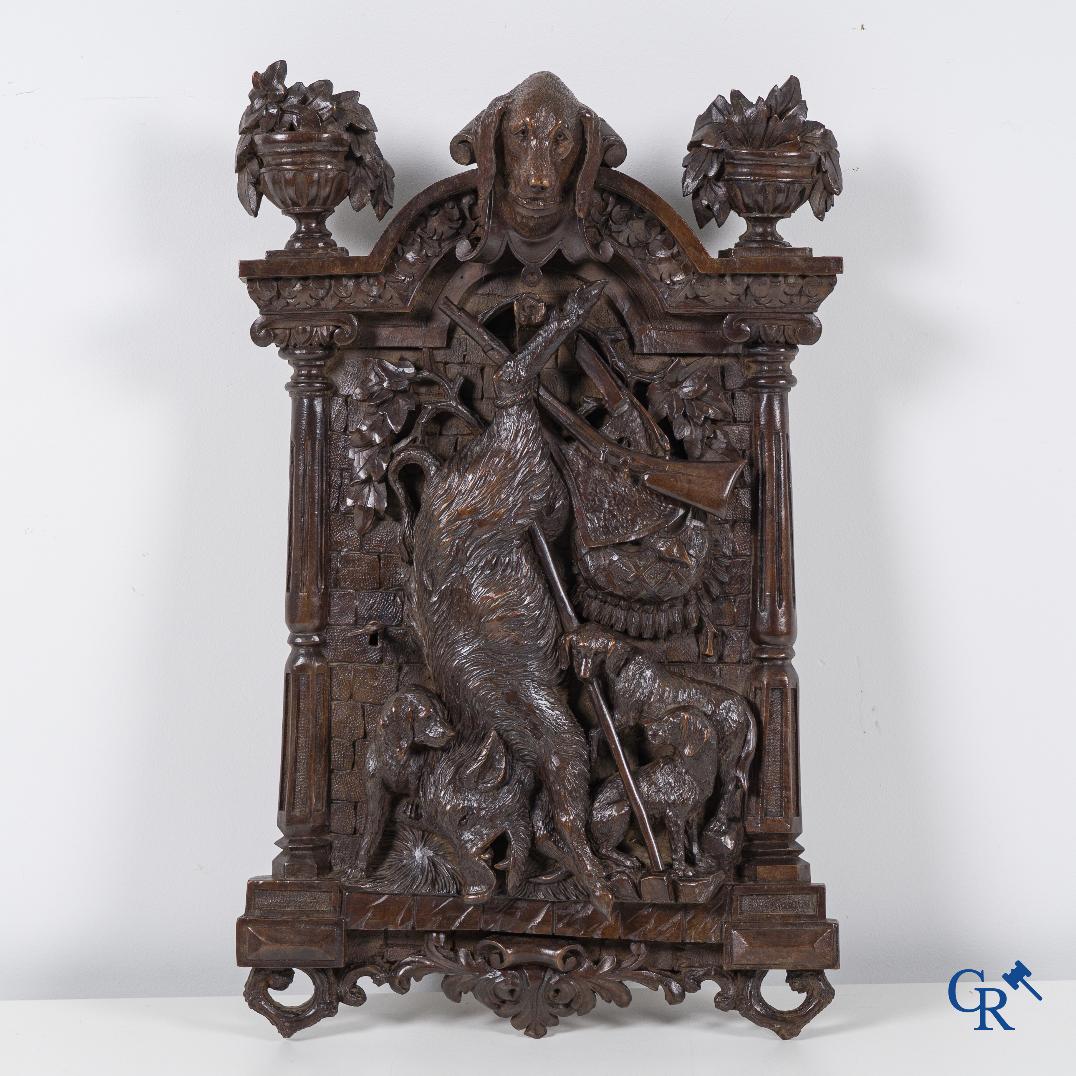 Black forest carvings. Key cabinet in richly sculpted wood with hunting scenes. Circa 1880.