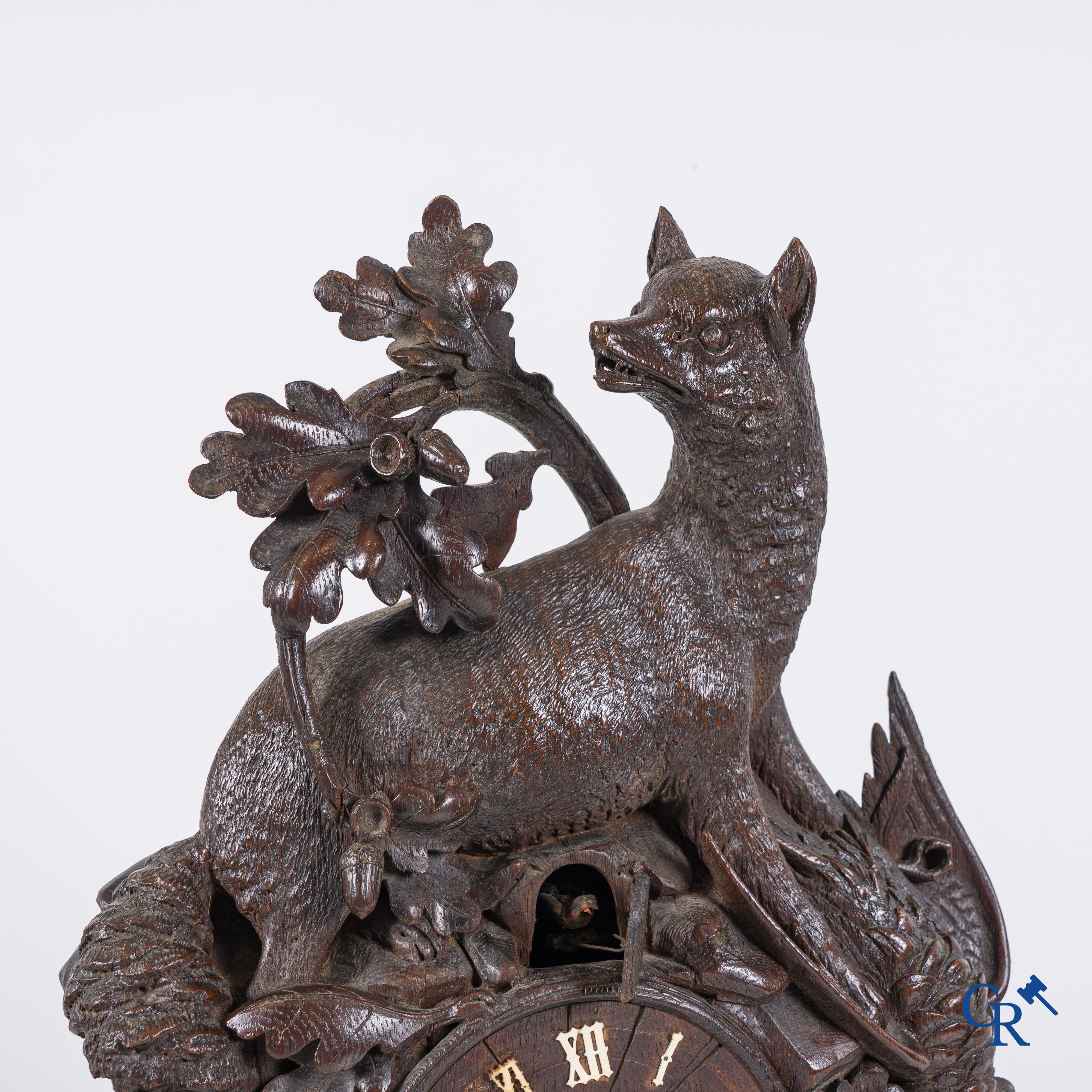 Black Forest, circa 1900. A large 3-piece cuckoo clock in sculpted wood.