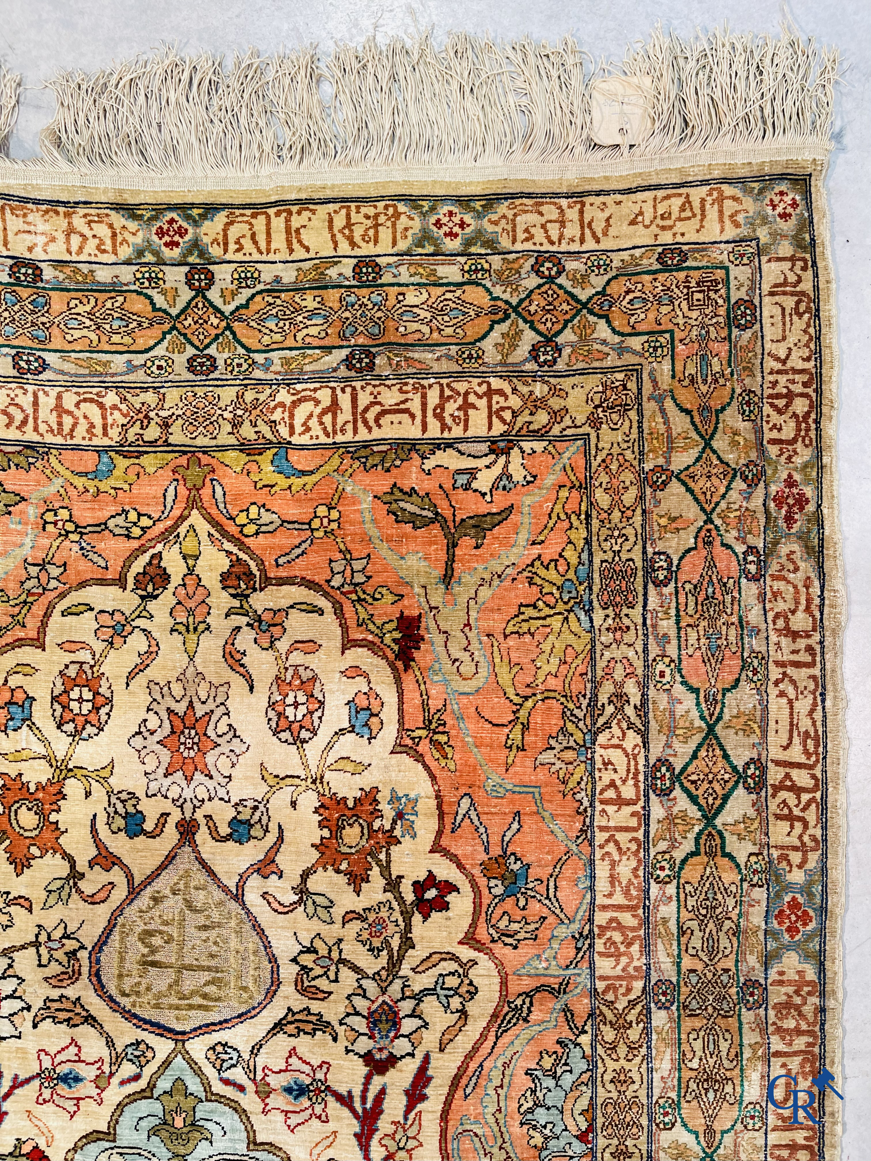 Oriental carpets, Hereke Turkey, a finely hand-knotted silk carpet with inscriptions and gold thread.