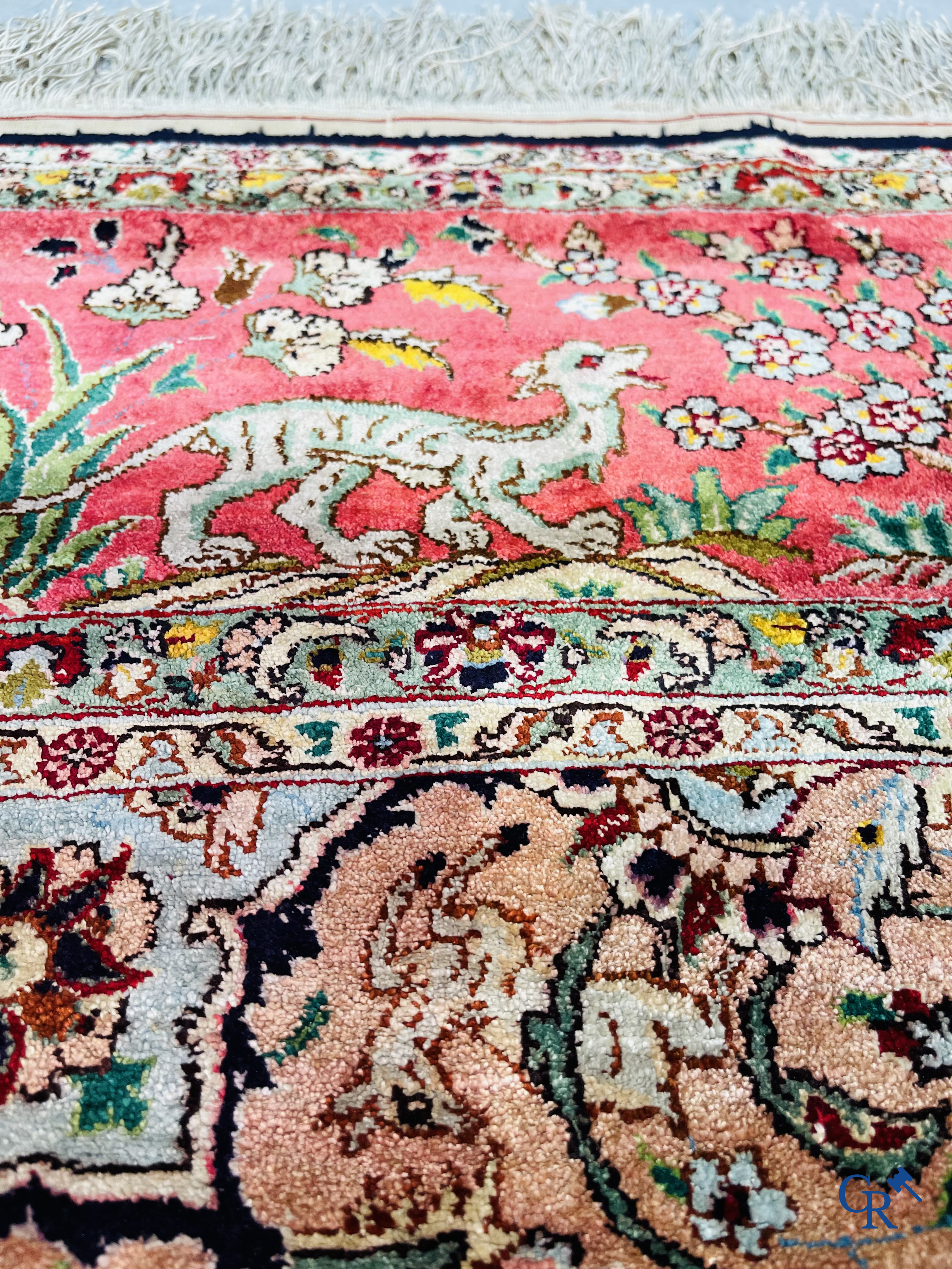 Oriental carpets: Tabriz, a finely hand-knotted silk carpet with forest animals and birds in a floral decor.