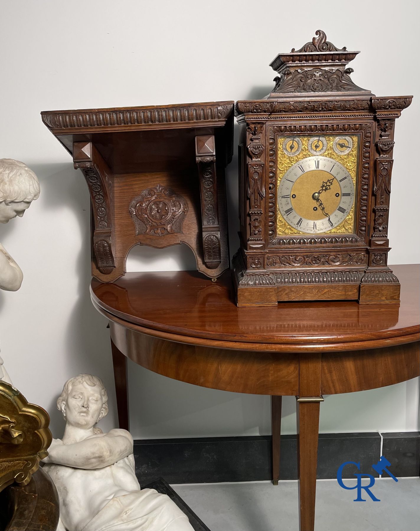 Clock with multiple bells and music in oak sculpted case with matching pedestal.