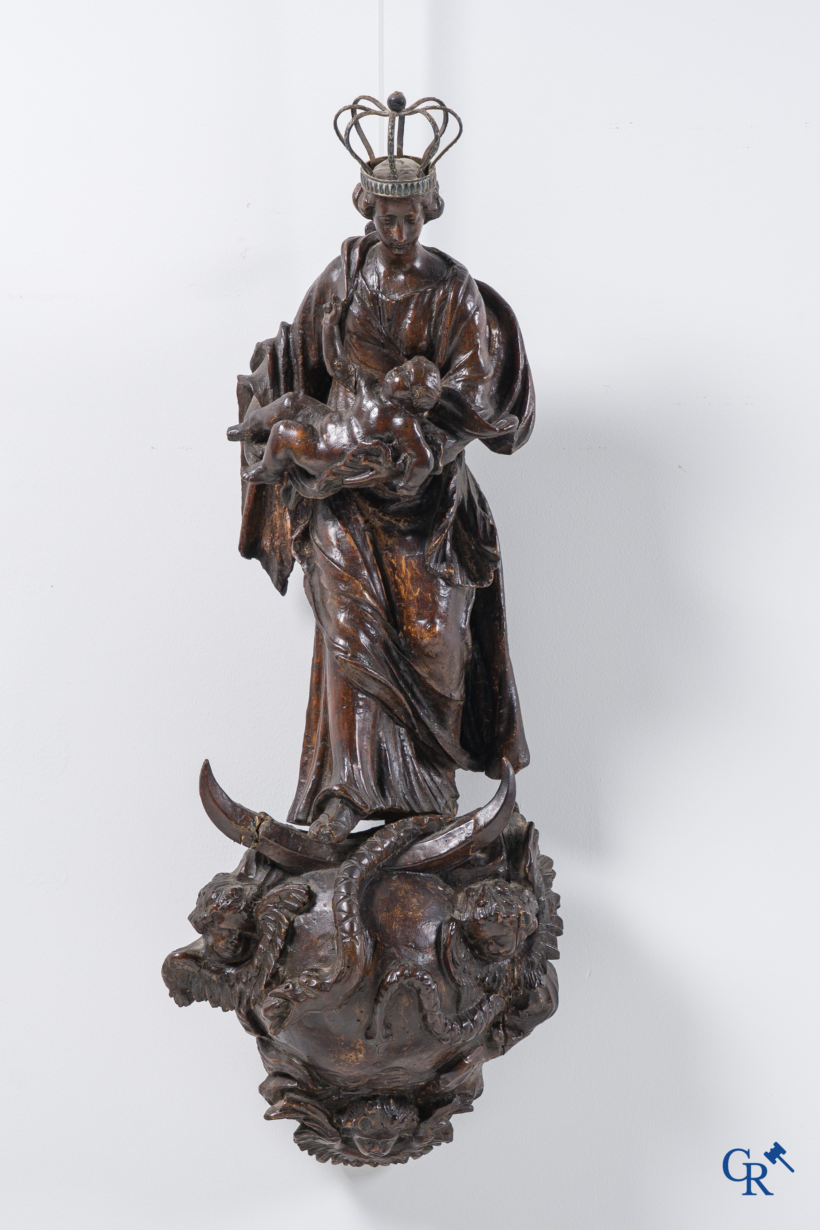 Imposing wooden sculpture of Mary with child, richly sculpted with angels and a dragon. 17th-18th century.