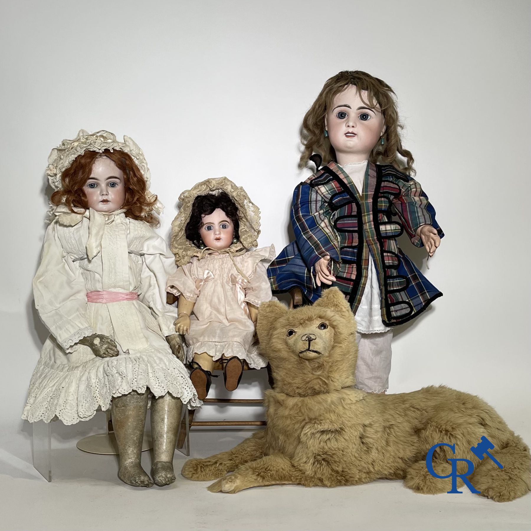 Toys: antique dolls. 3 dolls with porcelain head and a dog in fur.