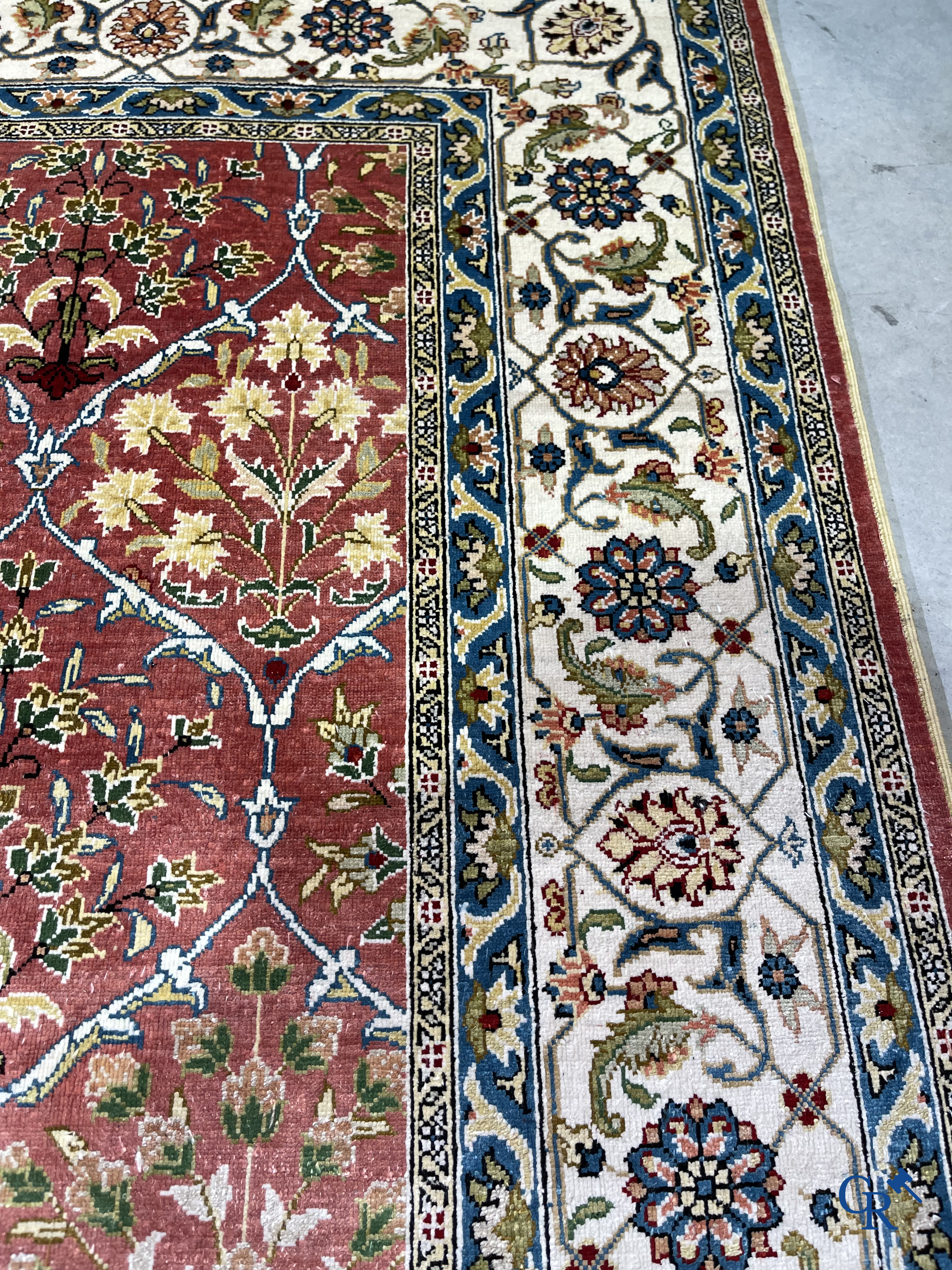 Oriental carpets: A finely hand-knotted carpet in wool and silk with floral decor.<br />
Signed.