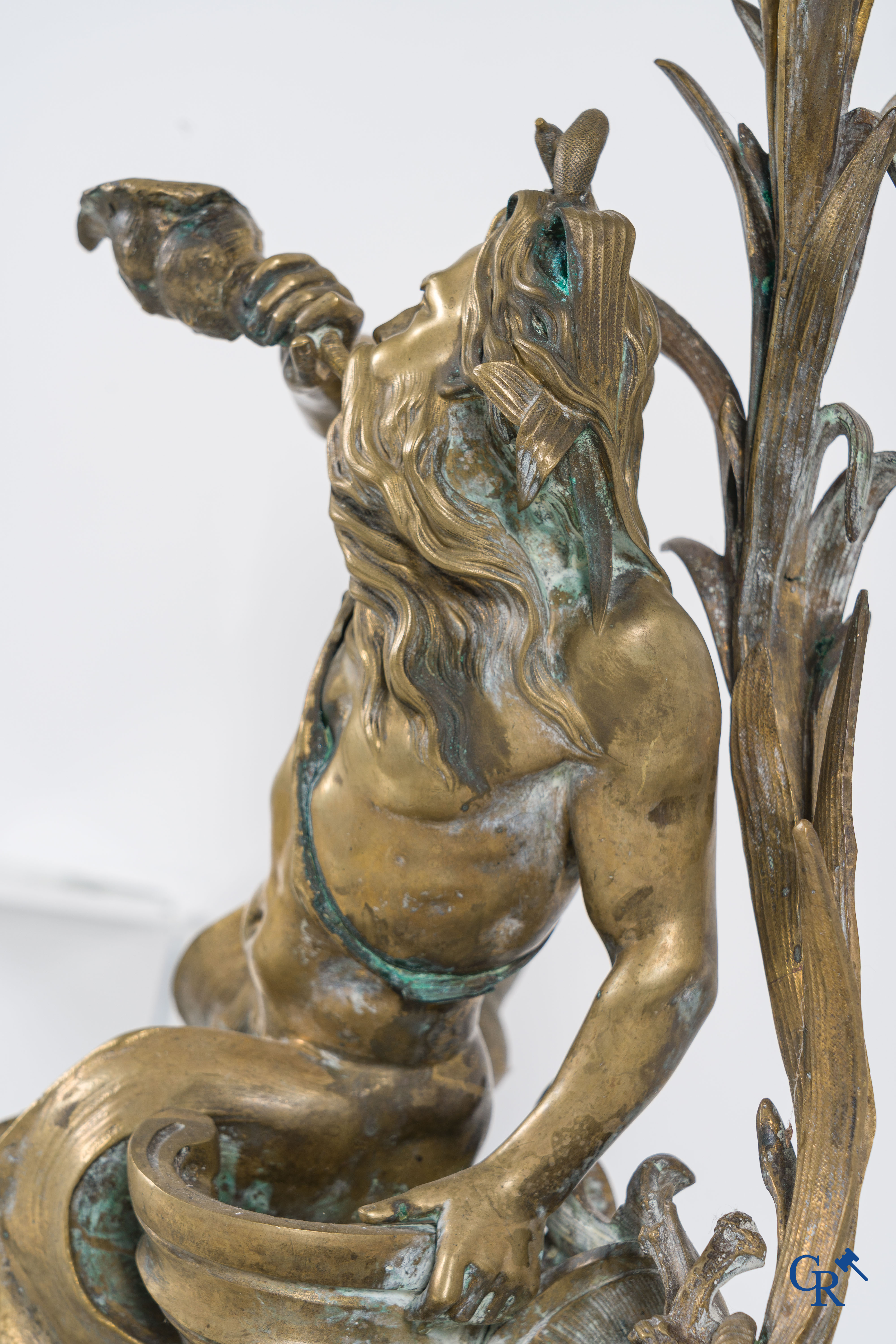 A large pair of finely chiseled bronze chenets with Tritons. Louis XV style. Napoleon III period.