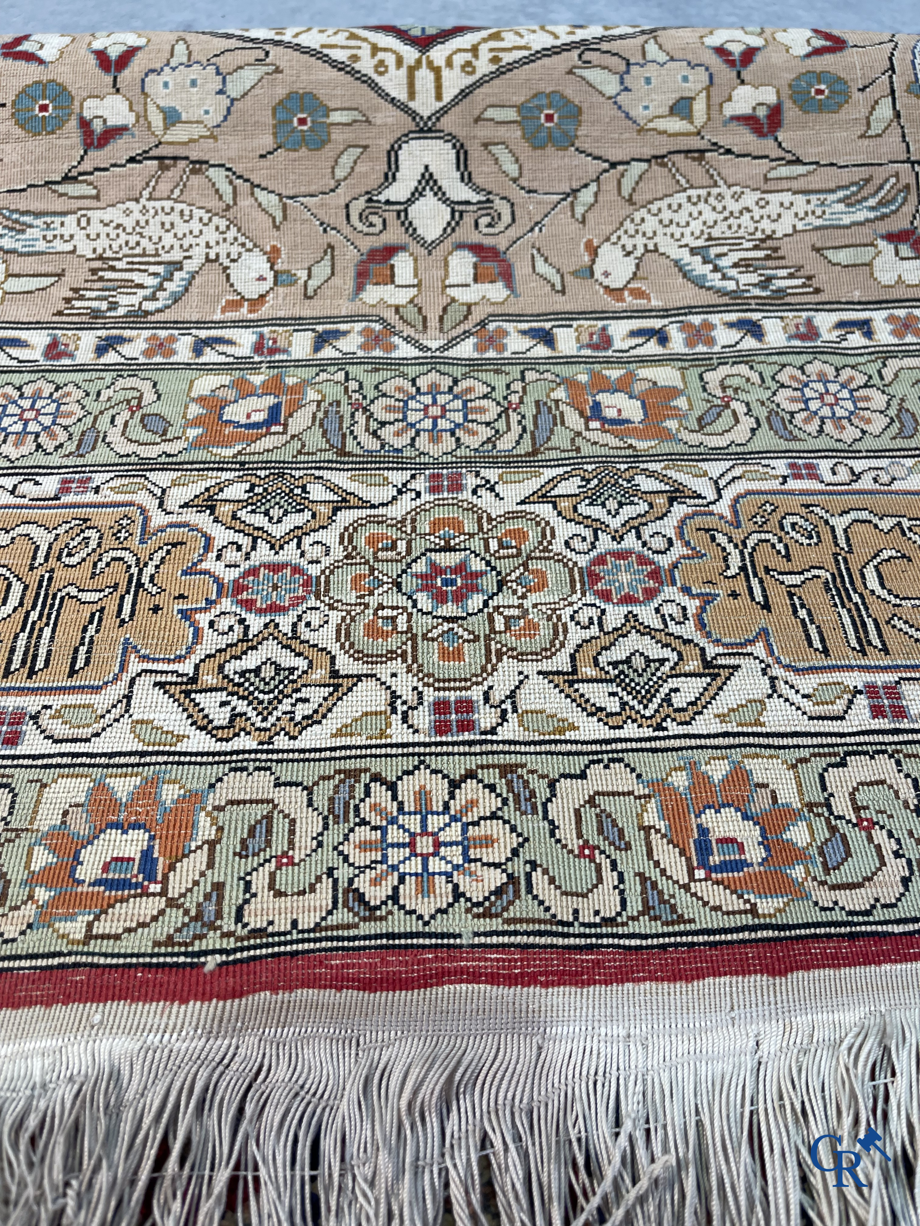 Oriental carpets: Hereke, a finely knotted silk carpet with inscriptions and birds in a floral decor.