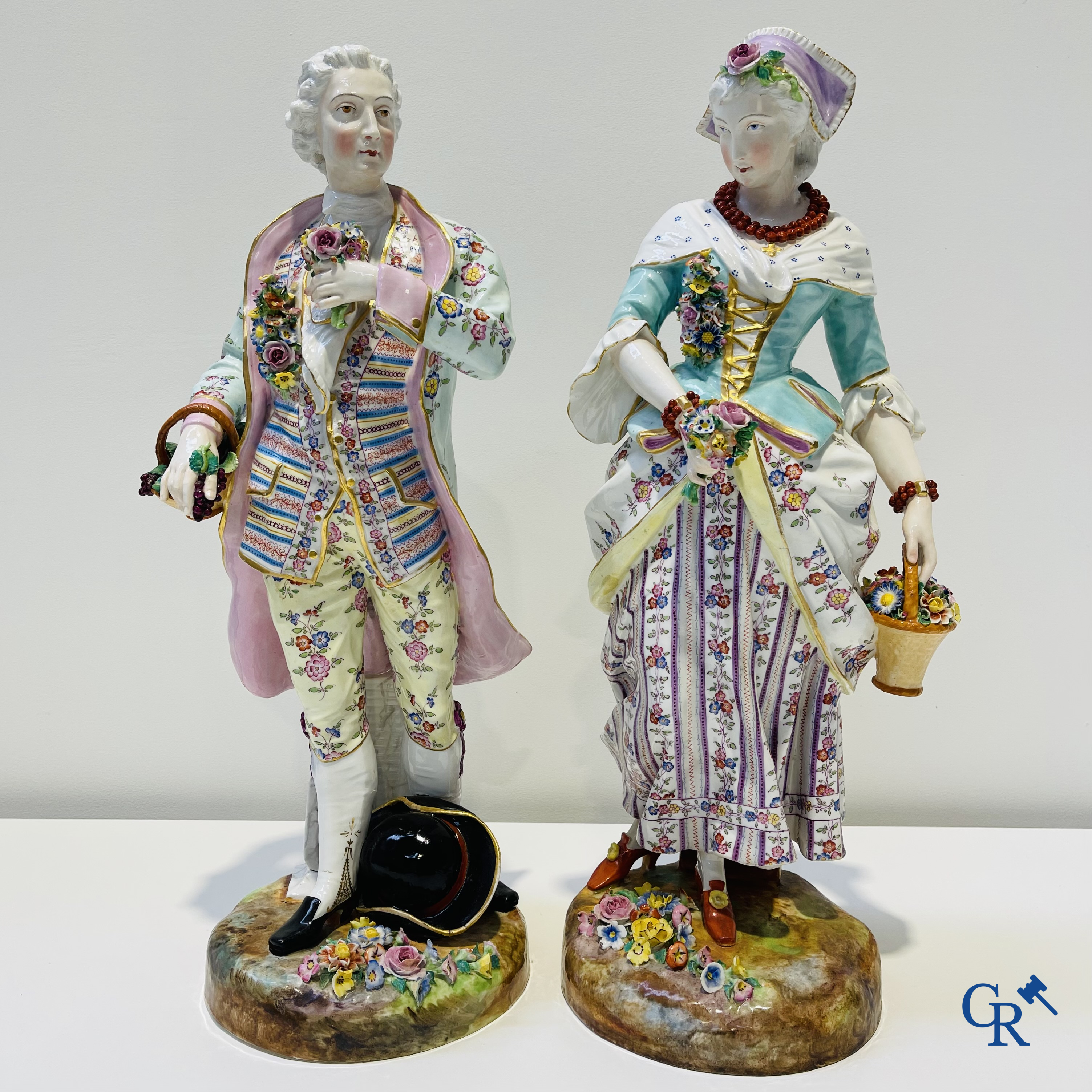 Exceptionally large pair of romantic statues in coloured and gilded porcelain in the manner of Meissen.