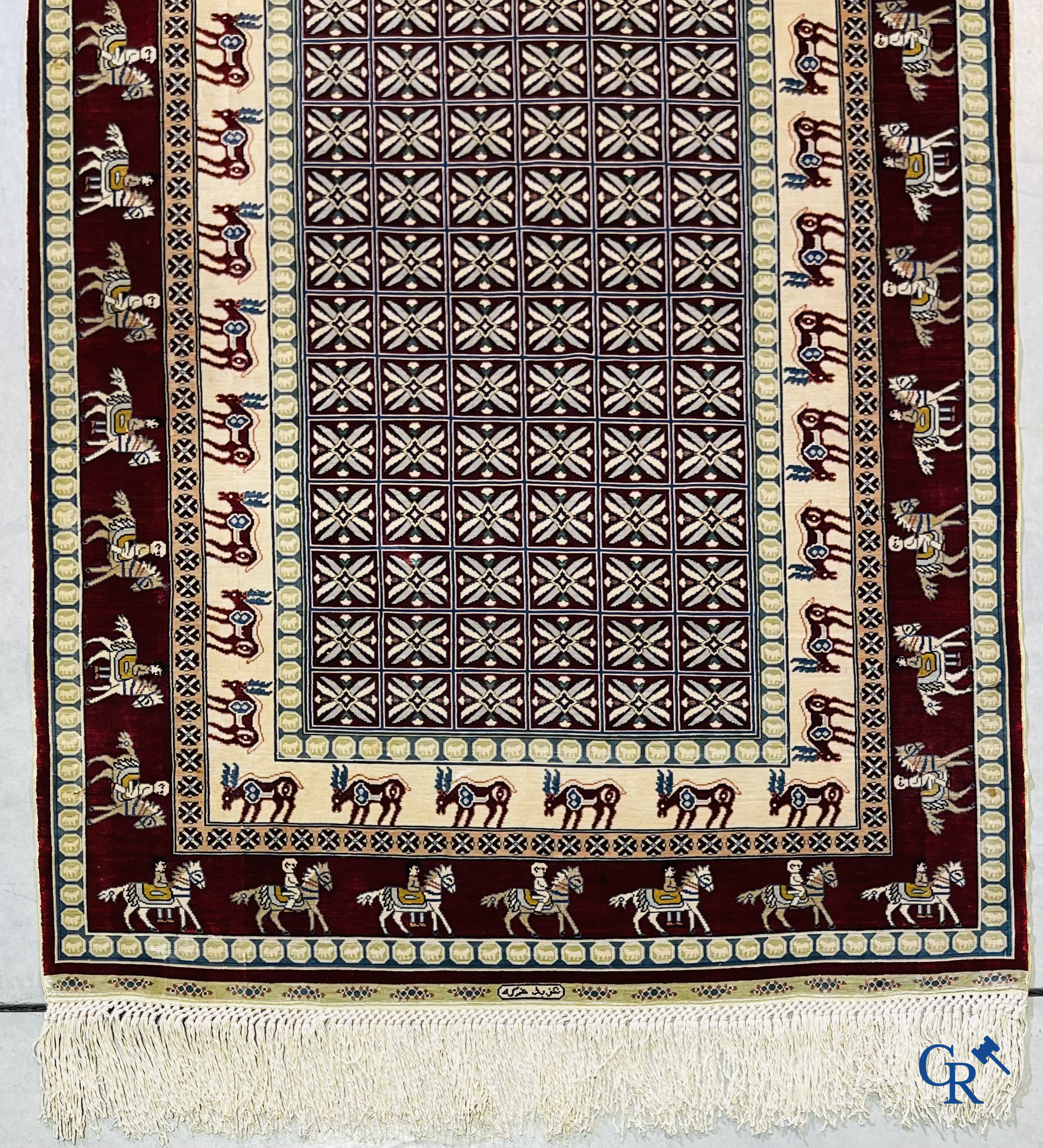 Oriental rugs: A small finely hand-knotted silk rug with deer and horsemen. Signed.