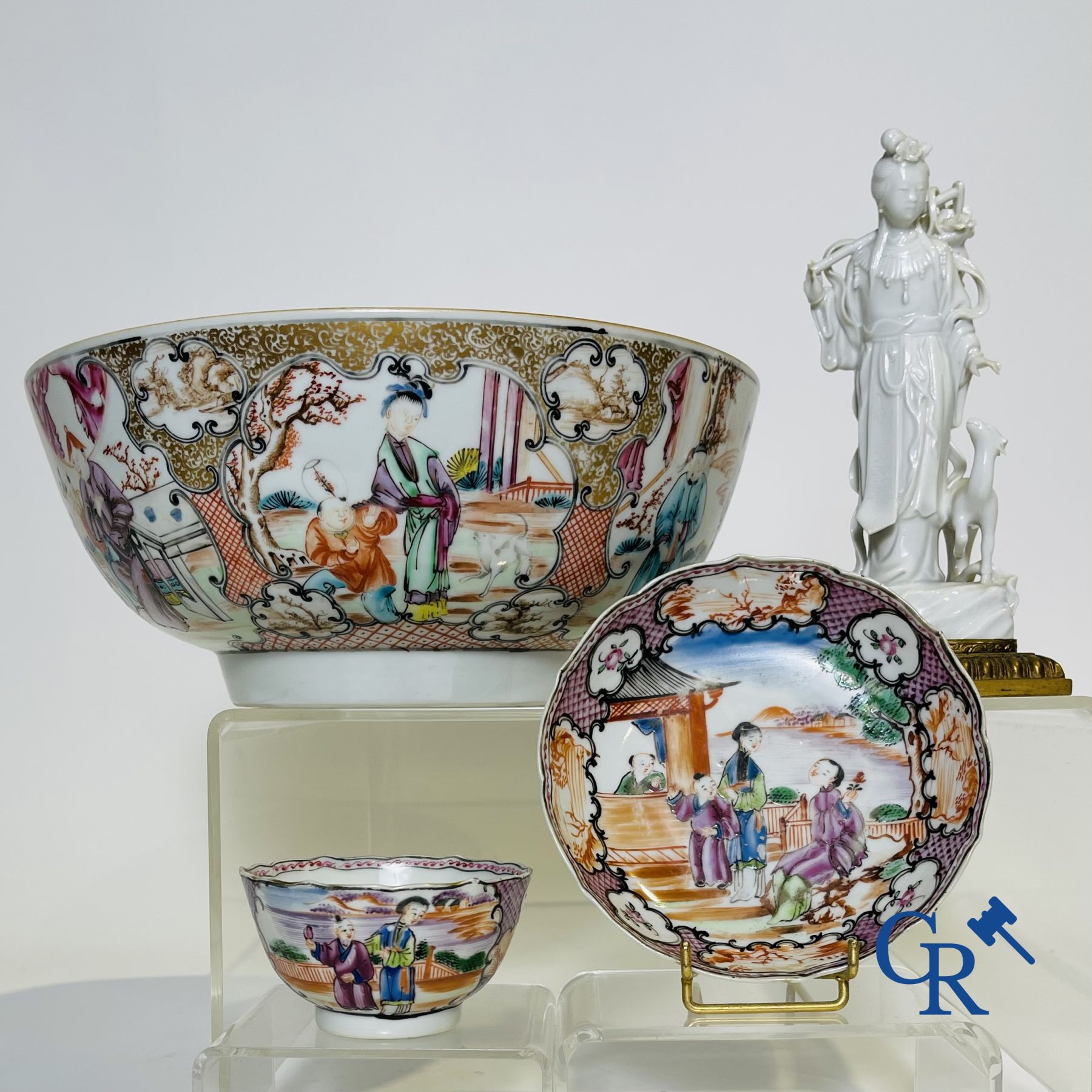 Un grand bol chinois decor mandarin en famille rose, une tasse et soucoupe en famille rose et une figurine en blanc de chine.