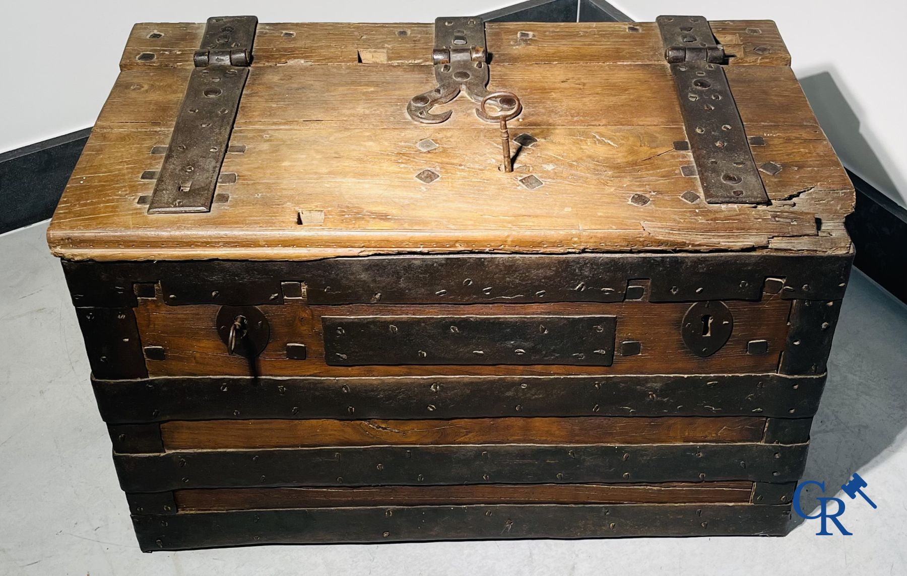 Antique wooden chest with hardware and lockwork in forging.