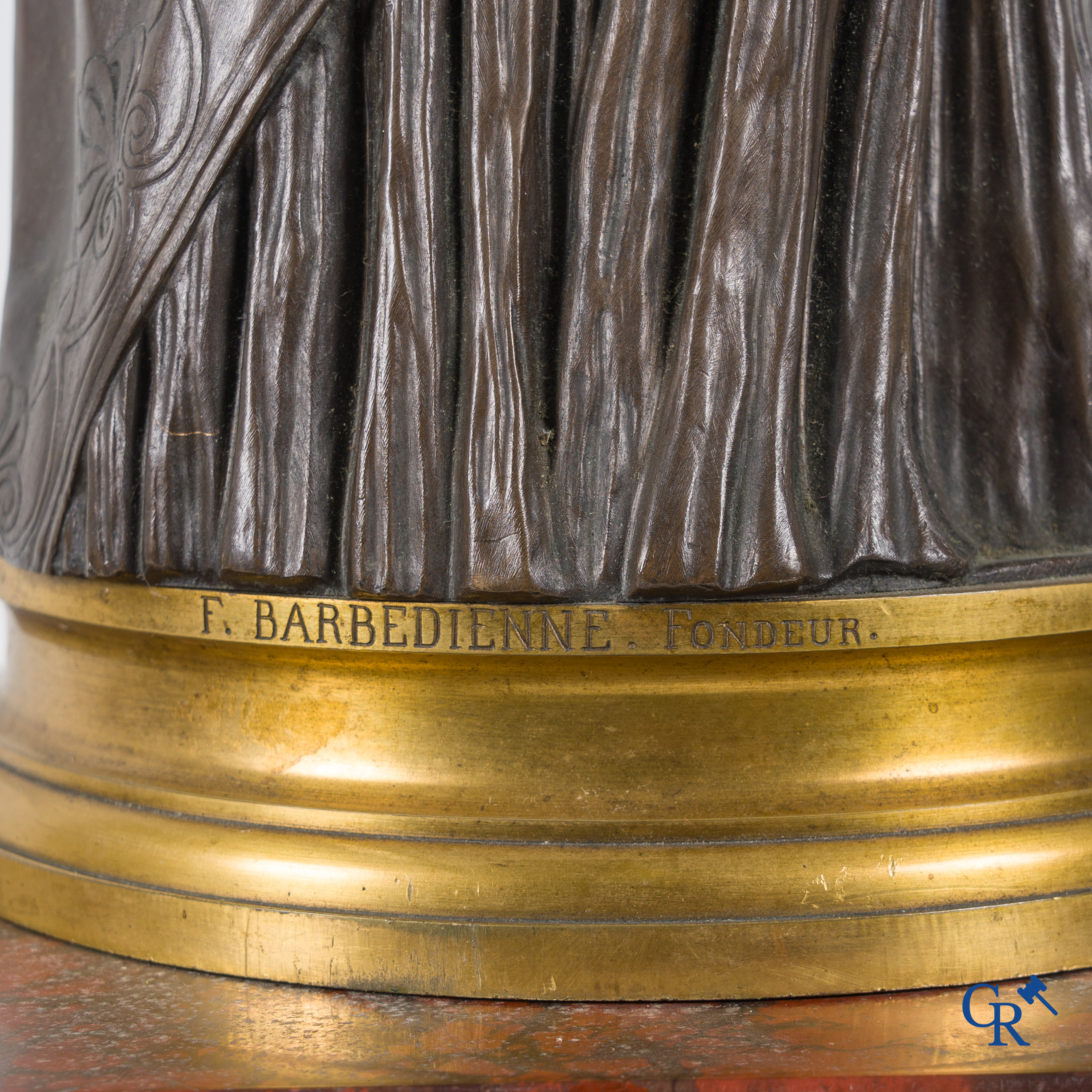 F. Barbedienne Fondeur, a bronze statue in the antique style with brown patina and gilding on a marble pedestal.