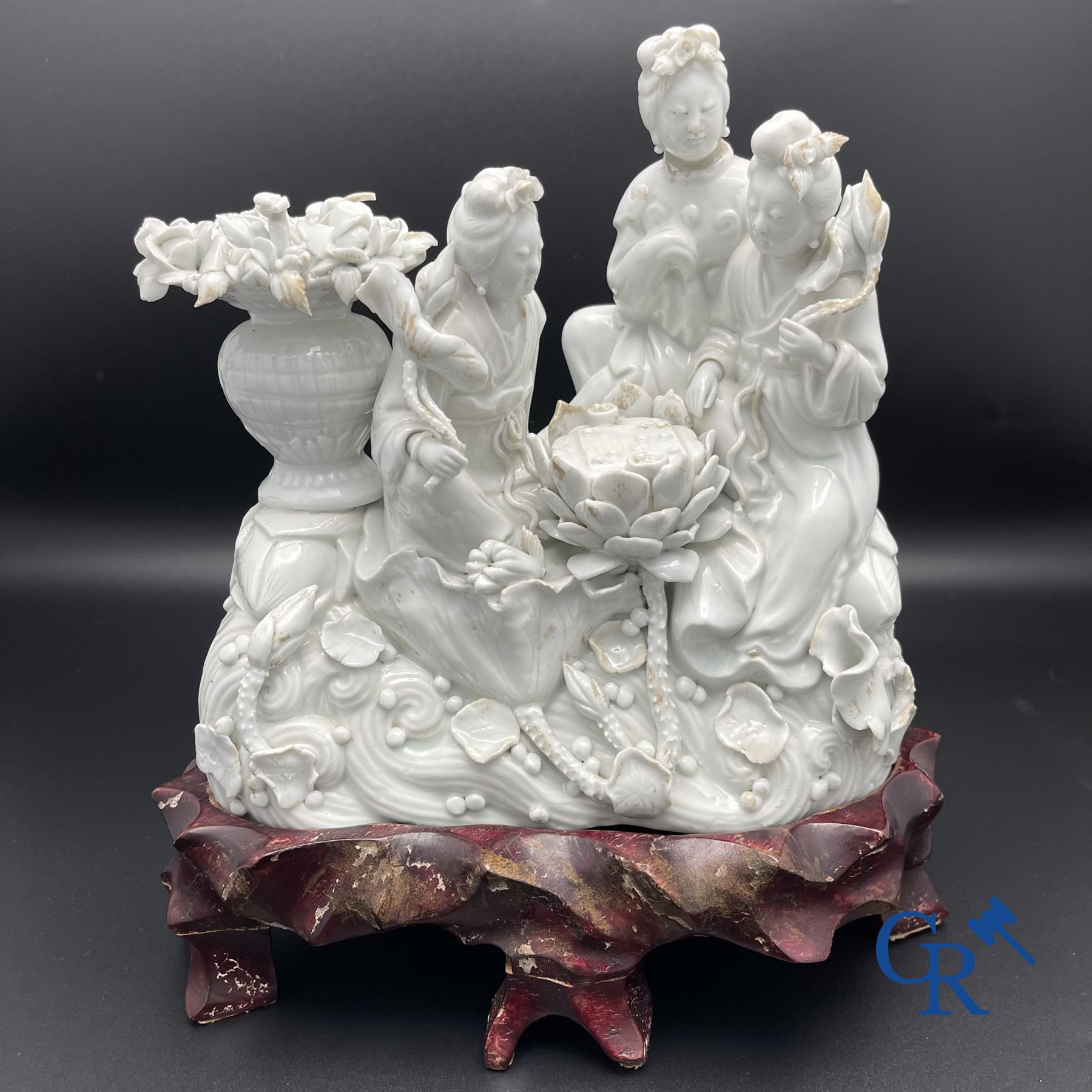 Chinese porcelain: A Buddhist lion and a group in blanc de Chine.