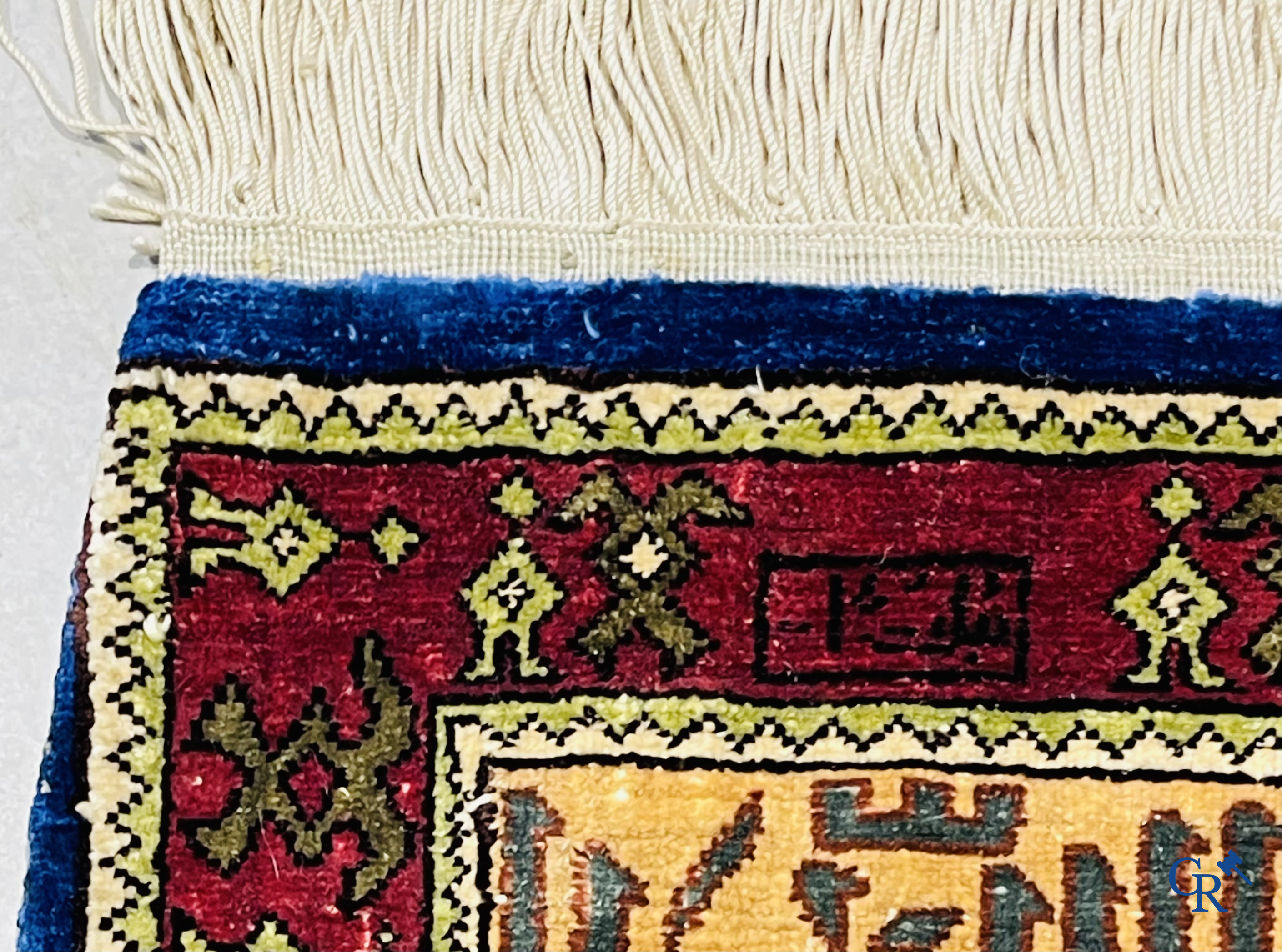 Oosterse tapijten. Een uiterst fijn handgeknoopt zijden tapijt met inscripties en gouddraad. Gesigneerd.