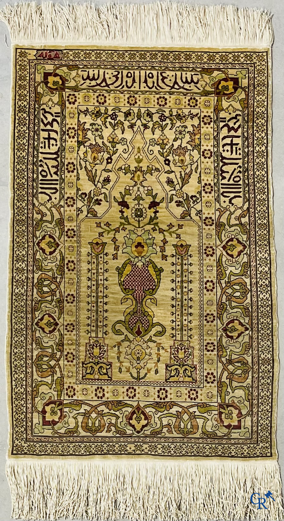 Oosterse tapijten. Hereke, een zijden tapijtje met inscripties. Gesigneerd.