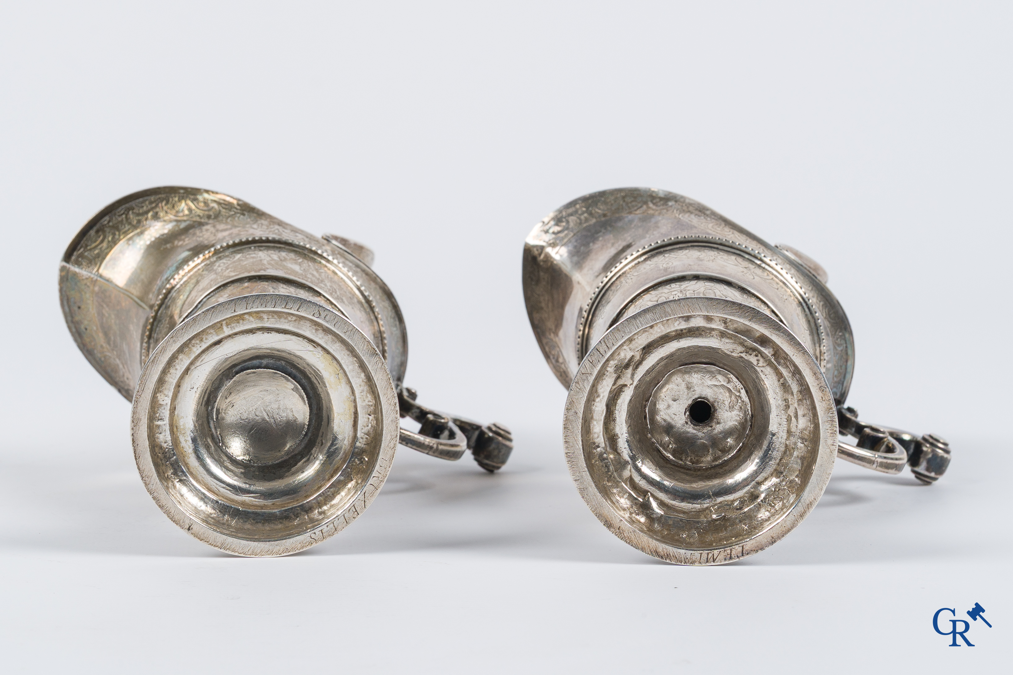 Zilver. Paar gegraveerde religieuze dekselkannen. Inscripties op de bodem "Temi ... Bruxelles". België 18e eeuw.