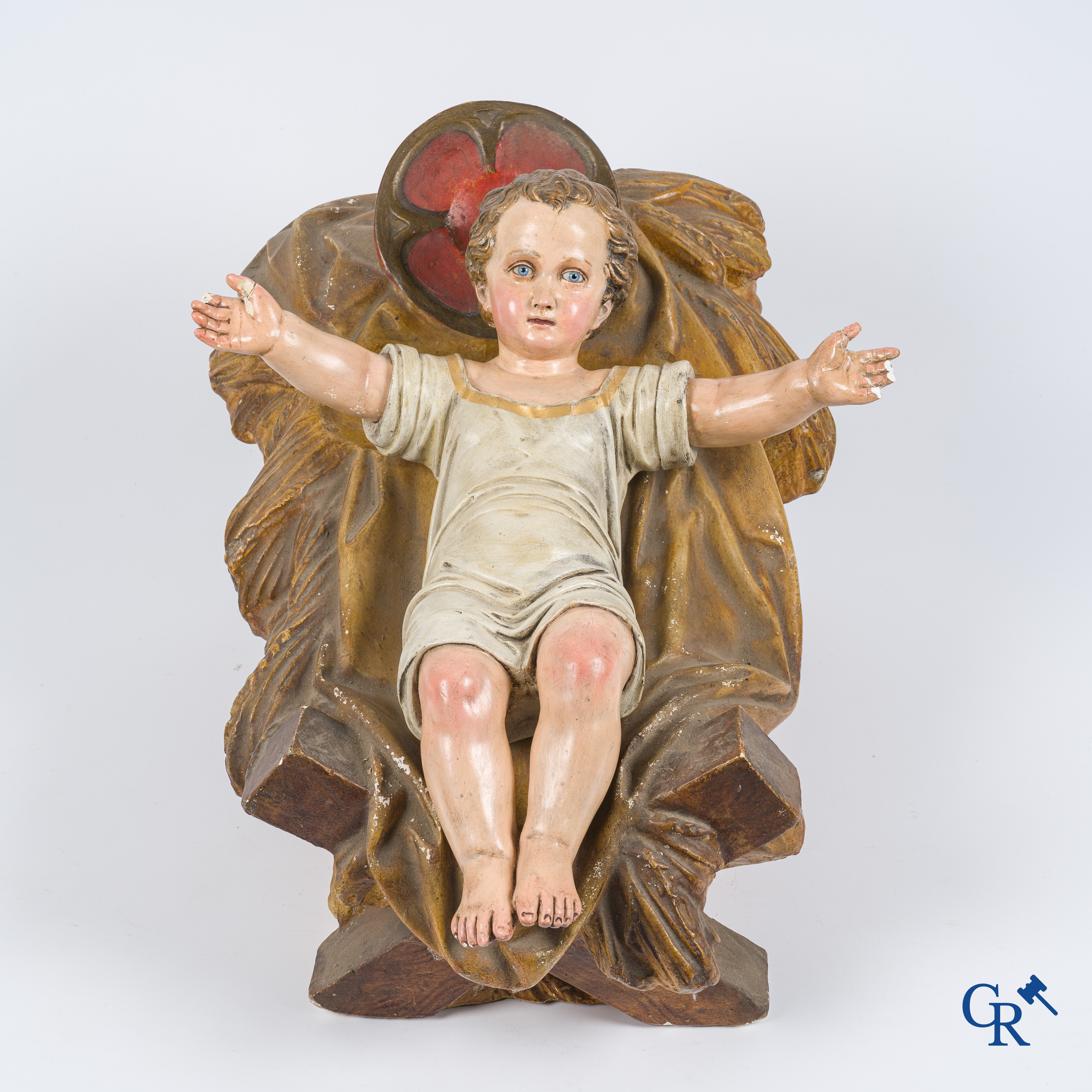 Religieuze objecten. Een grote kribbe met het Jezus kind in gepolychromeerd plaaster. Glazen ogen en gemerkt Paris.