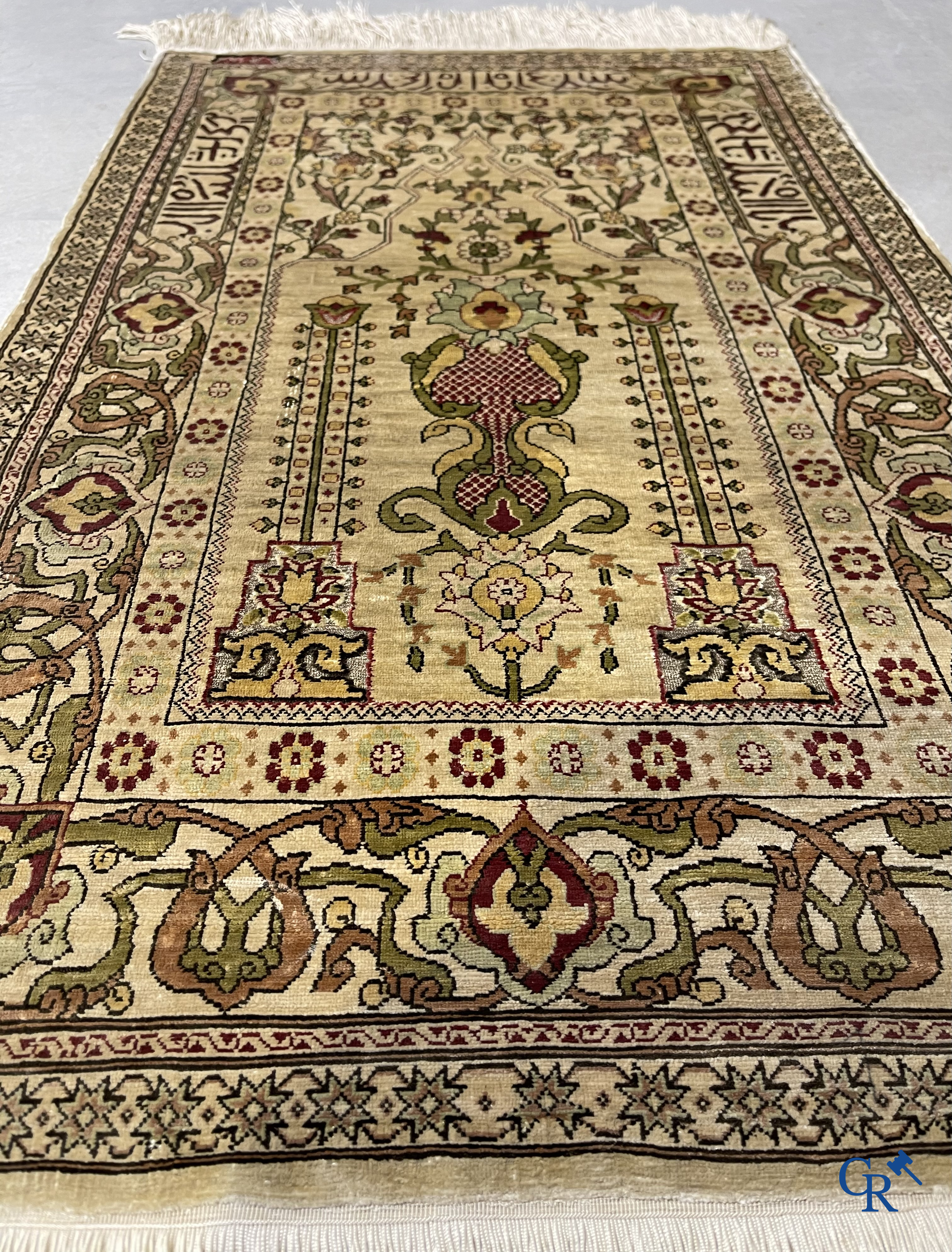 Oosterse tapijten. Hereke, een zijden tapijtje met inscripties. Gesigneerd.