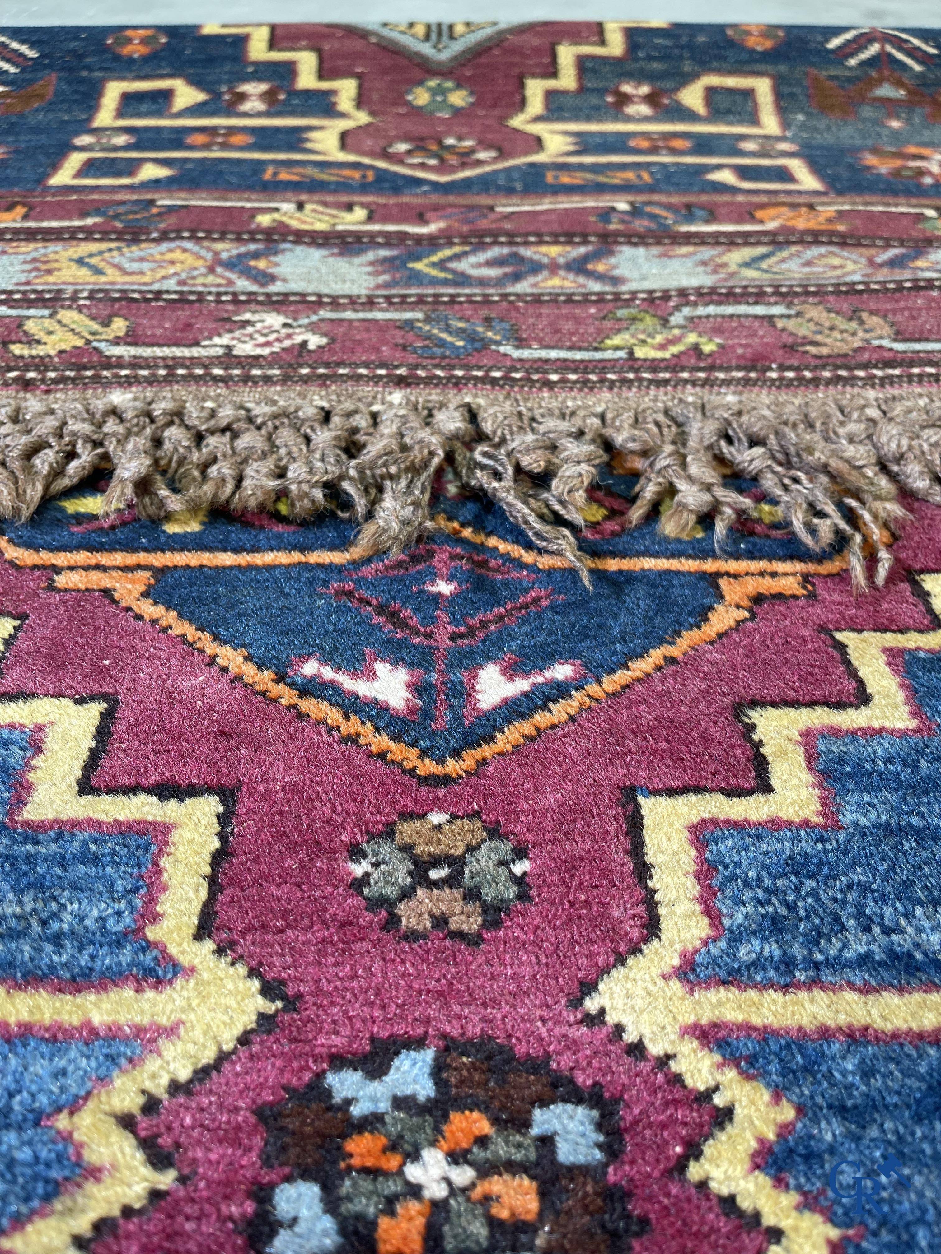 Oriental carpets, an antique hand-knotted Oriental carpet with motifs on a blue background.