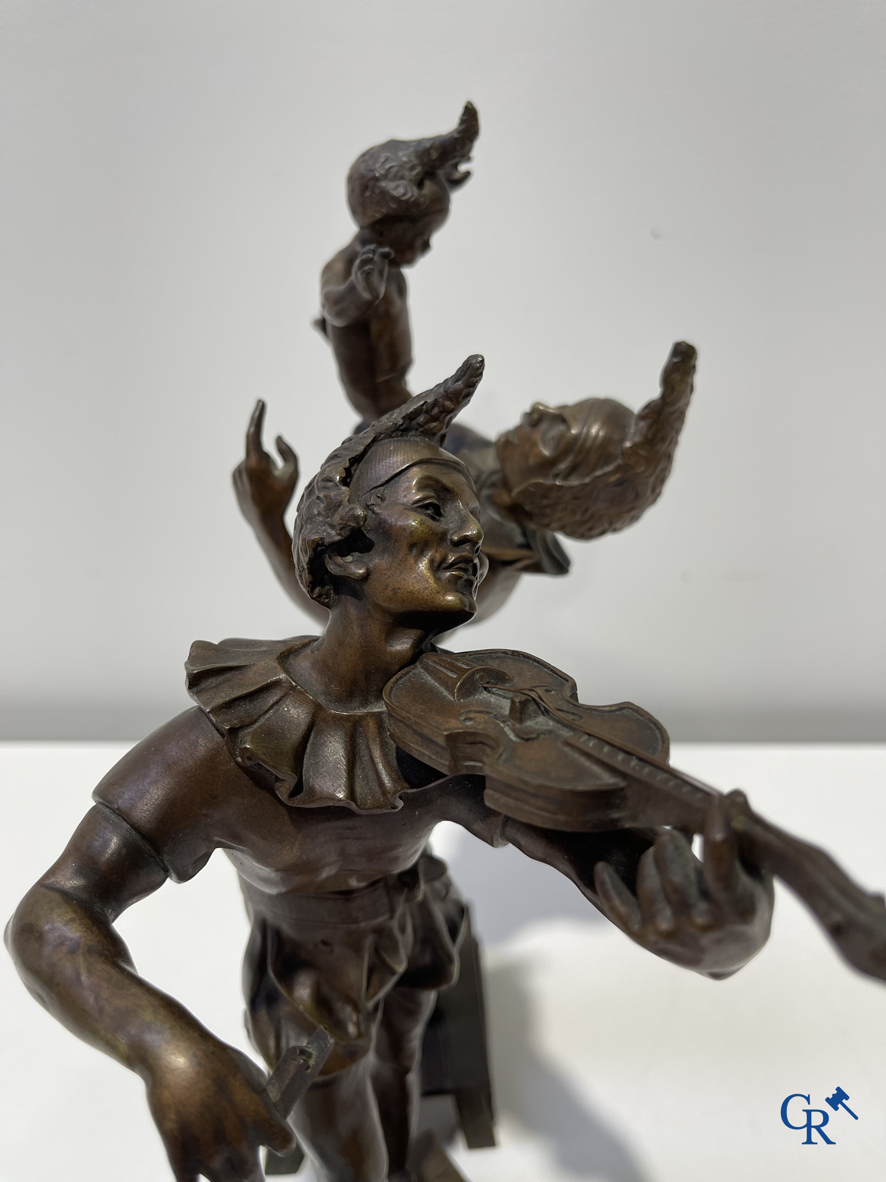 Auguste de Wever (1836-1910) Pair of bronze statues, harlequin with child and music playing harlequin.