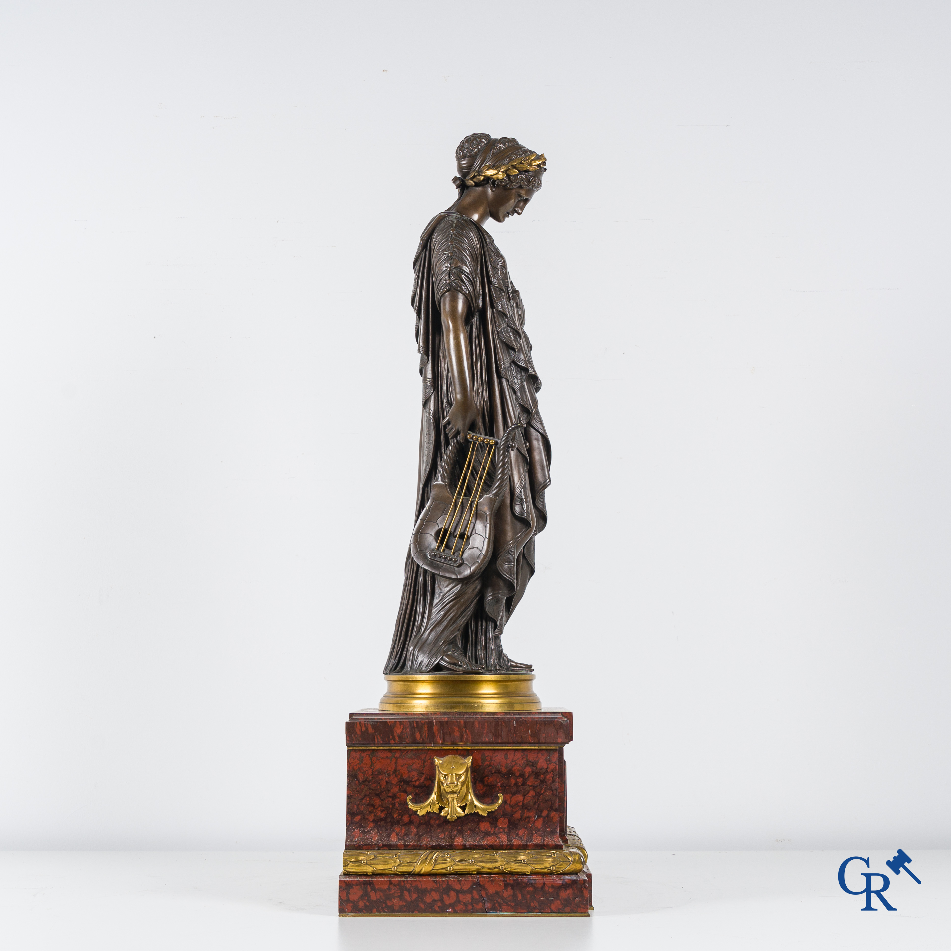 F. Barbedienne Fondeur, a bronze statue in the antique style with brown patina and gilding on a marble pedestal.