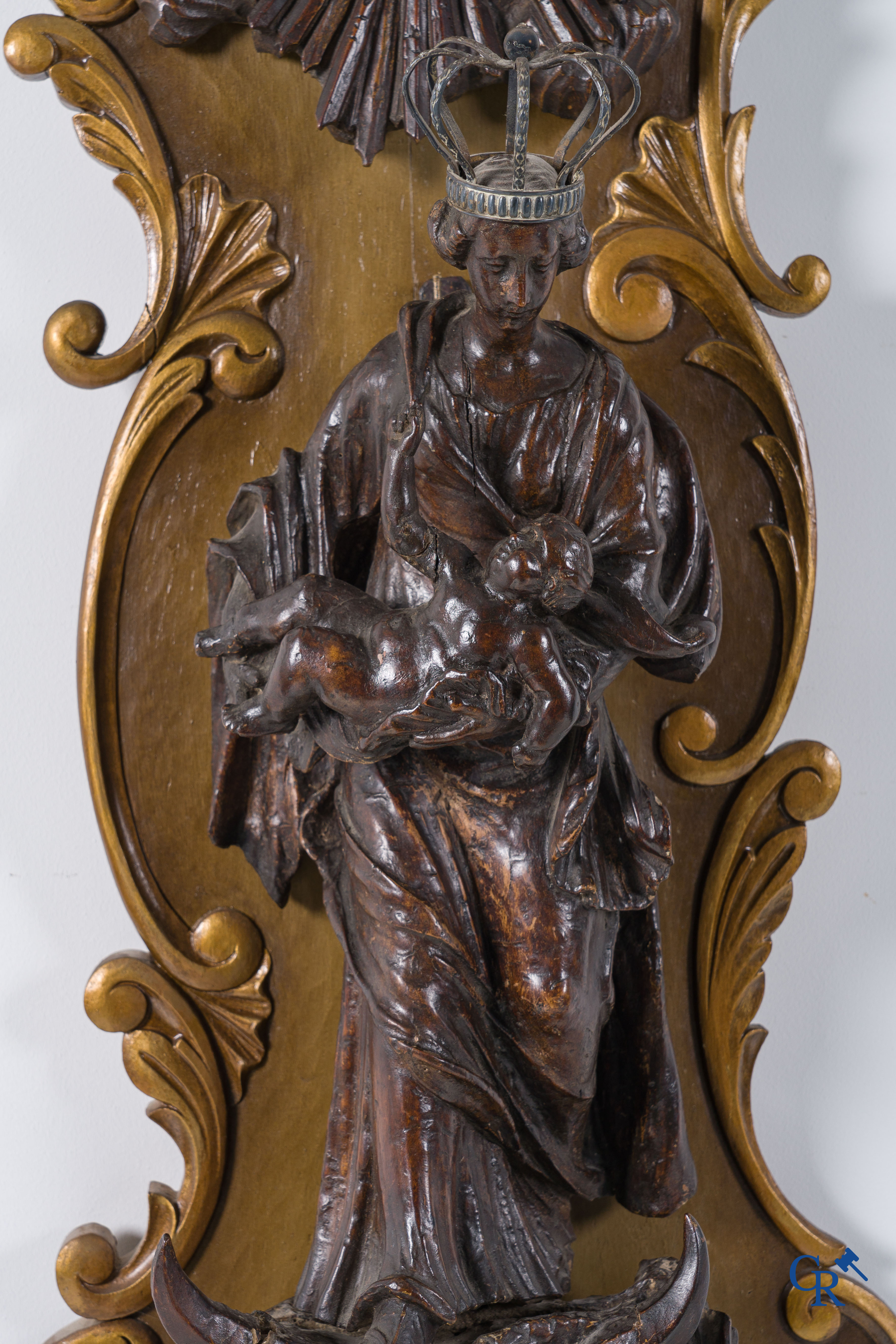 Imposing wooden sculpture of Mary with child, richly sculpted with angels and a dragon. 17th-18th century.