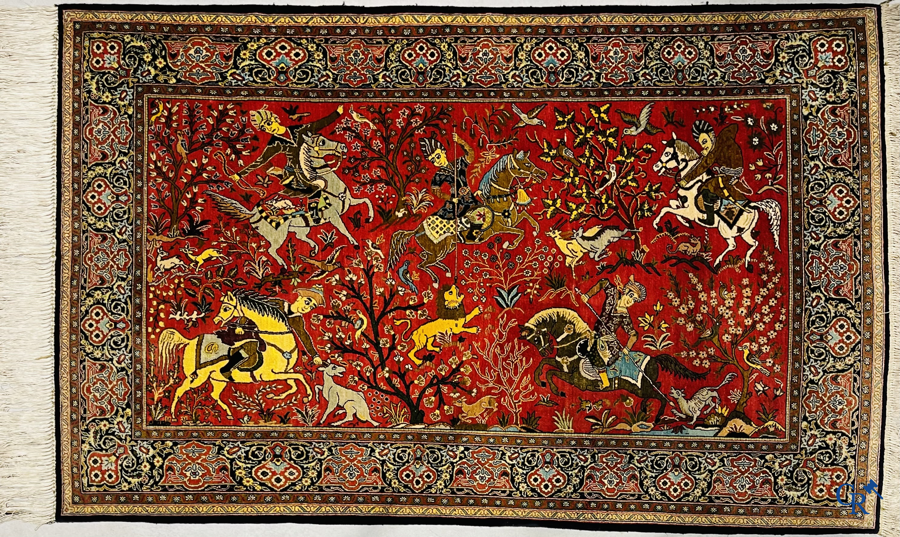 Oriental carpets, a Persian carpet in silk with a scene of hunters on horseback.