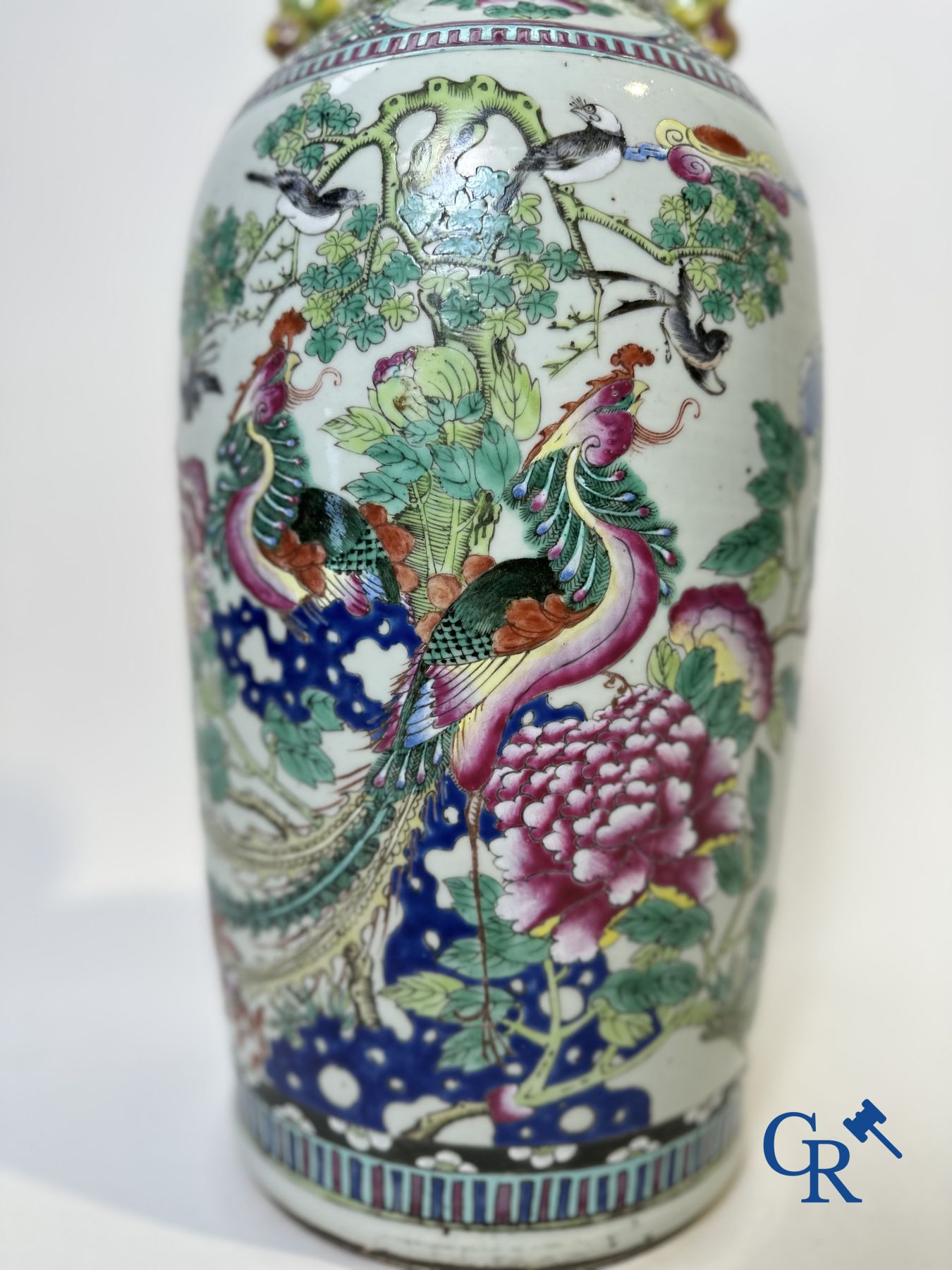 Chinese porcelain: A Chinese famille rose vase with a decor of Buddhist lions, phoenixes, birds and peonies.