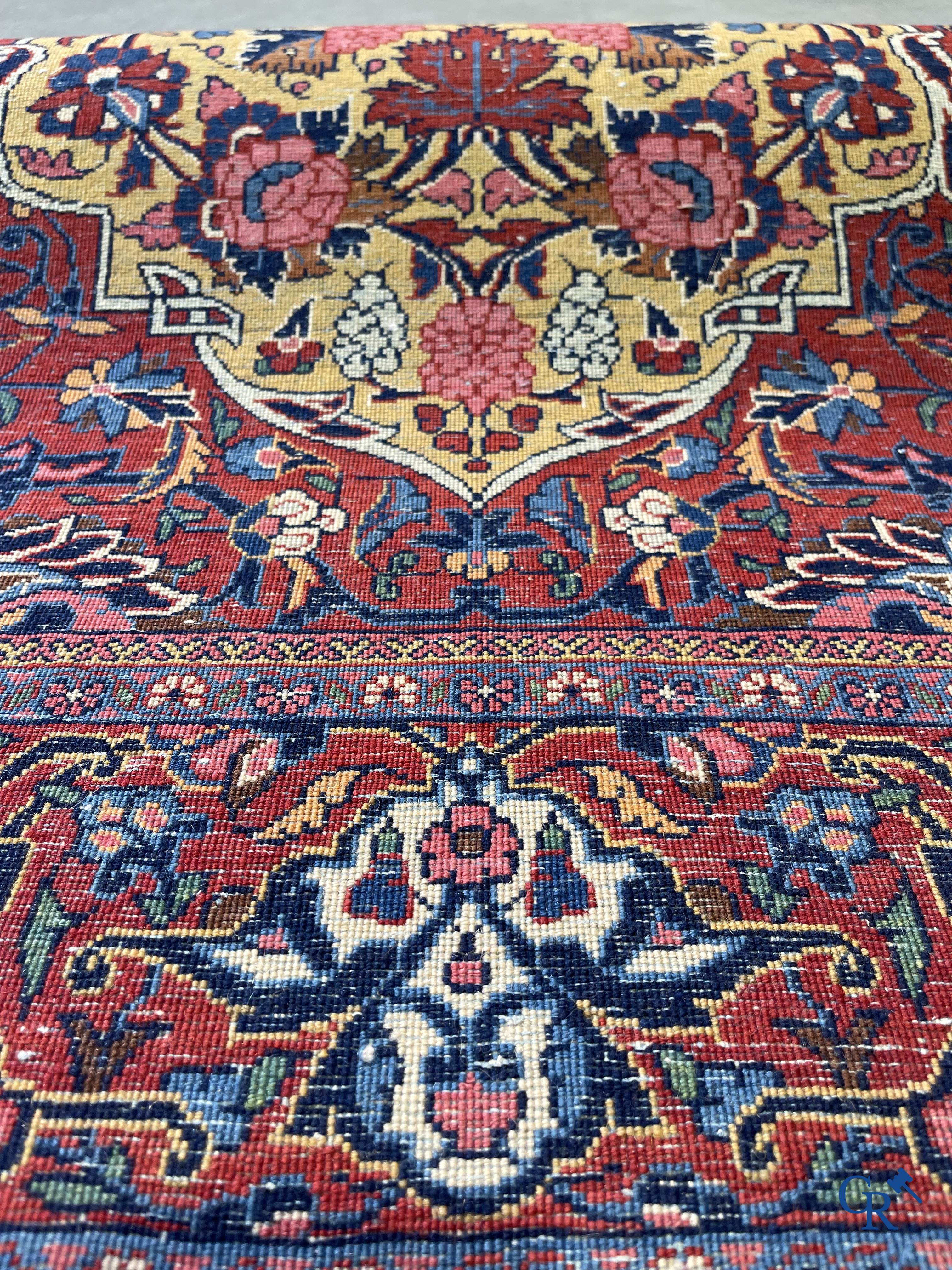 Oriental carpets: Iran. 2 antique hand-knotted Persian carpets with floral decor.