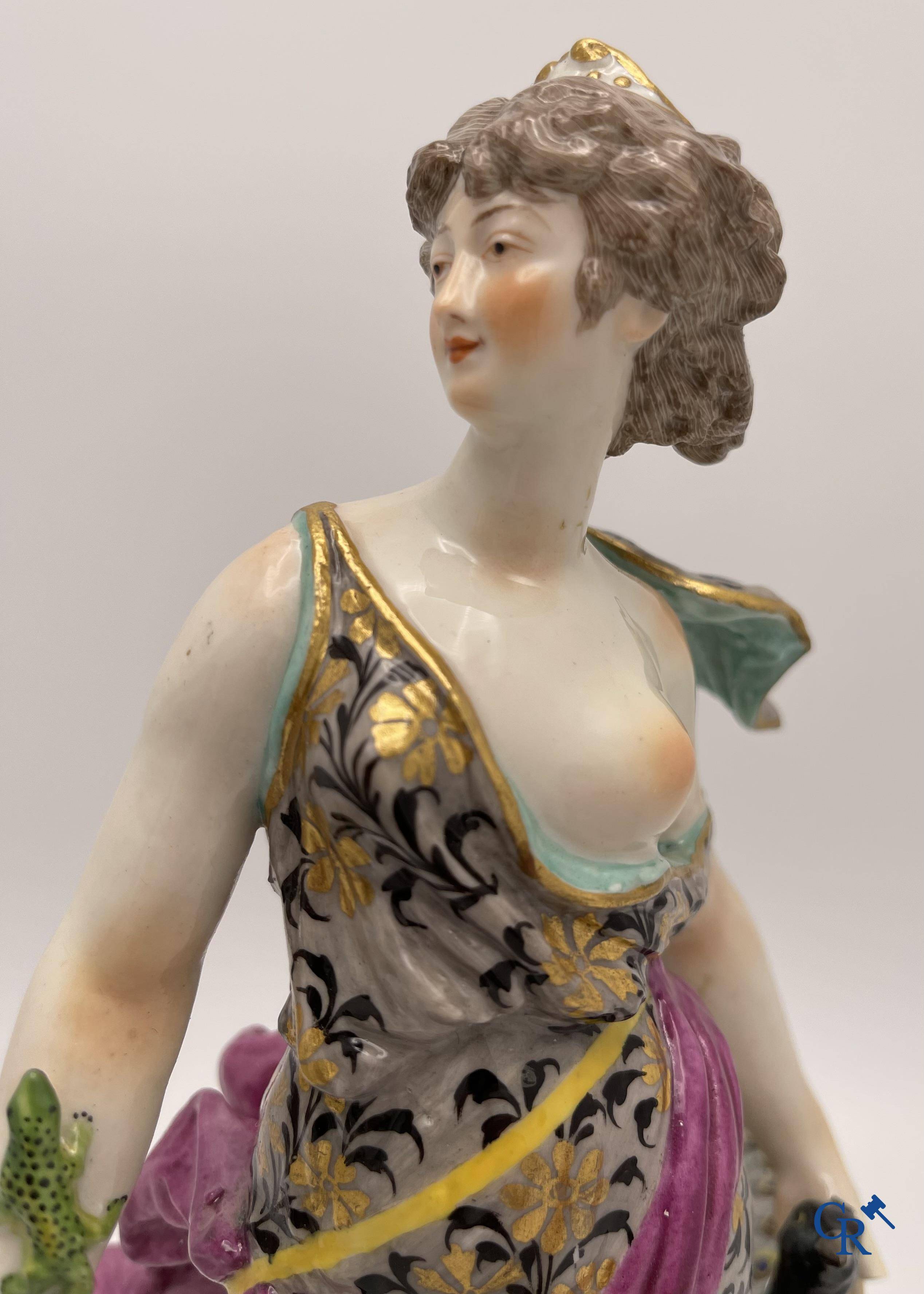 A pair of polychrome porcelain figures in the manner of Meissen.