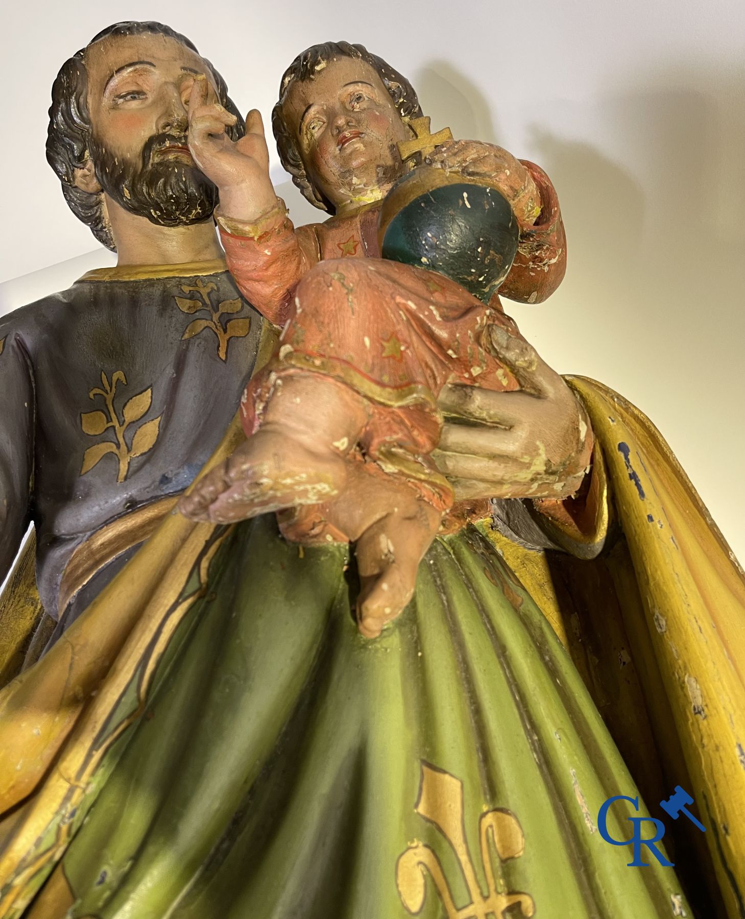 A 19th century wooden statue of Christ and a wooden display case with plaster representation of Mary with child.