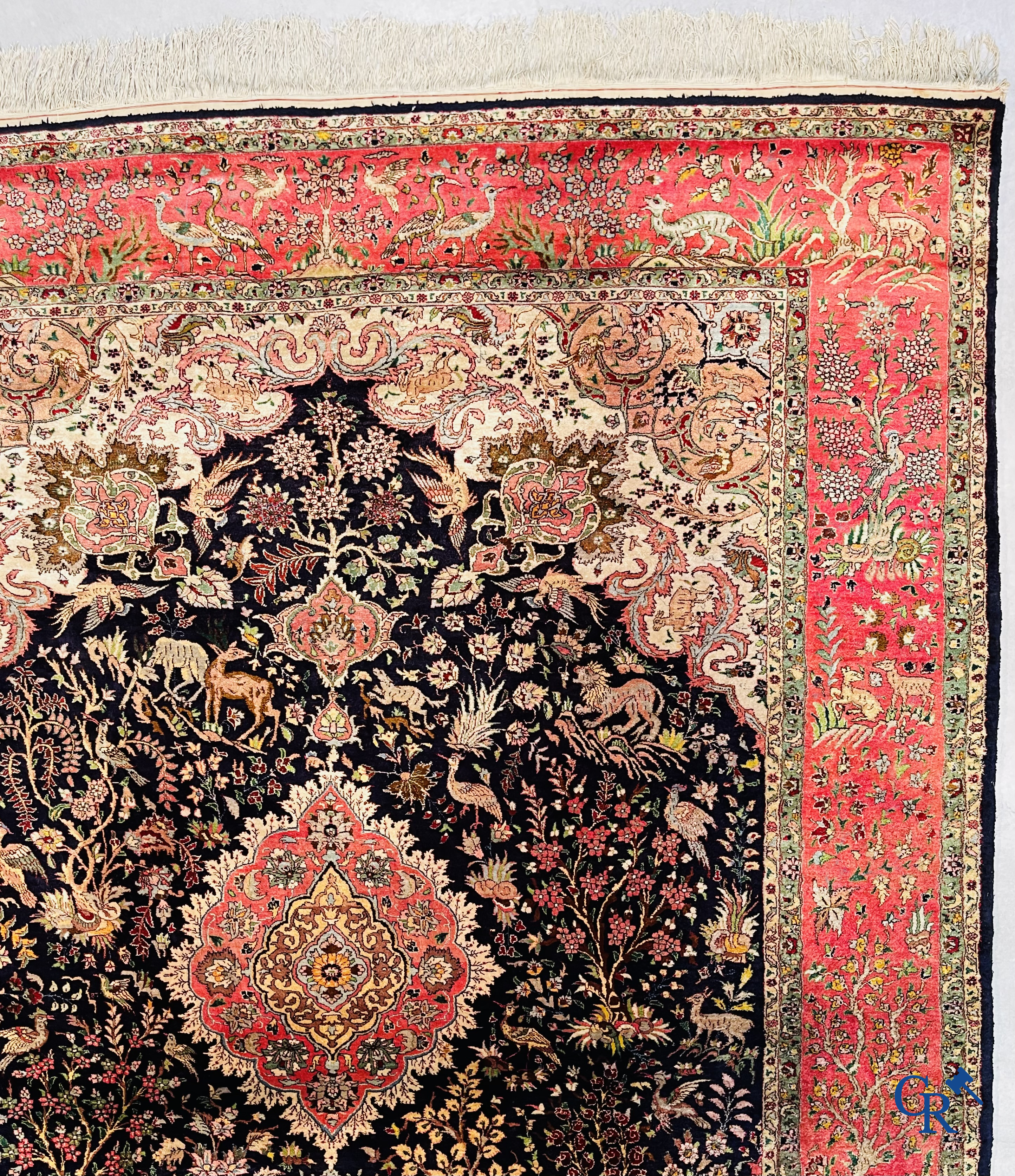 Oriental carpets: Tabriz, a finely hand-knotted silk carpet with forest animals and birds in a floral decor.