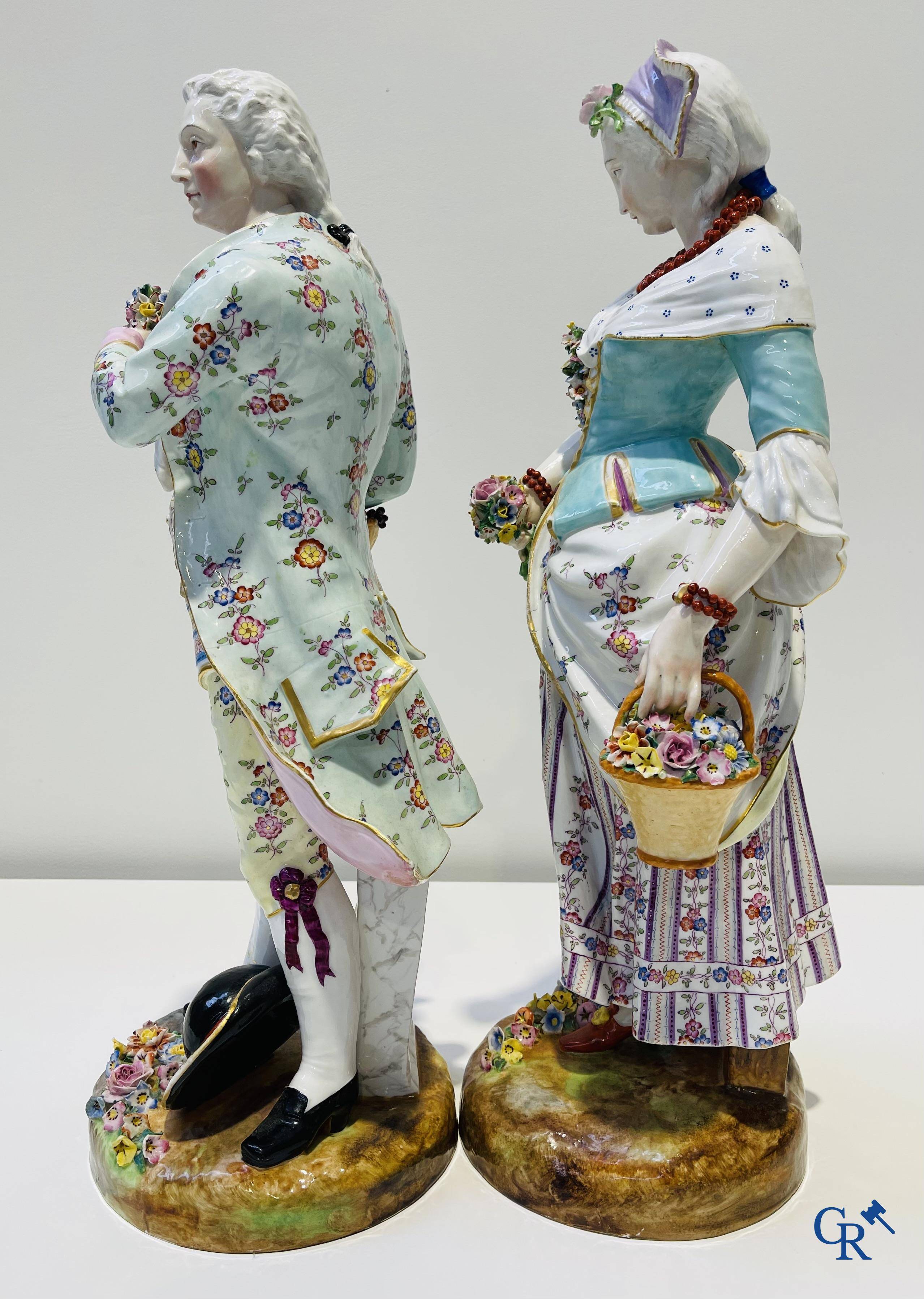 Exceptionally large pair of romantic statues in coloured and gilded porcelain in the manner of Meissen.