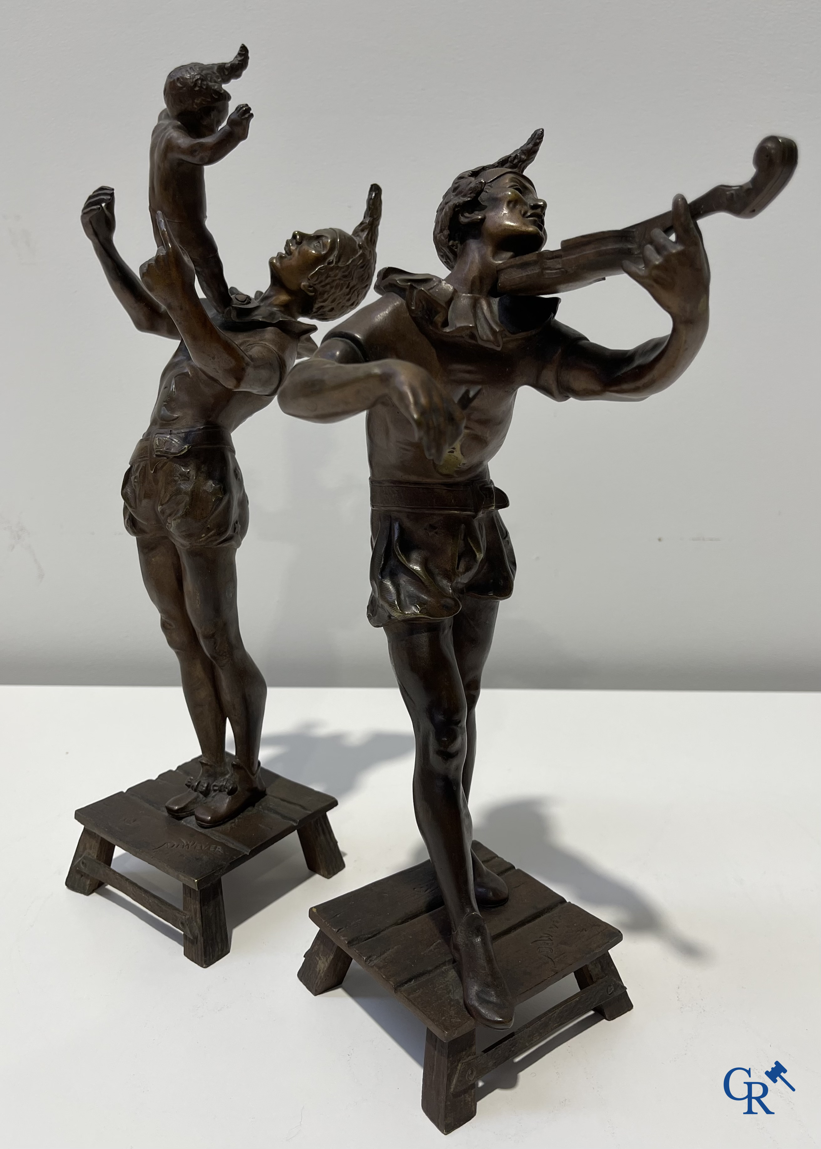 Auguste de Wever (1836-1910) Pair of bronze statues, harlequin with child and music playing harlequin.