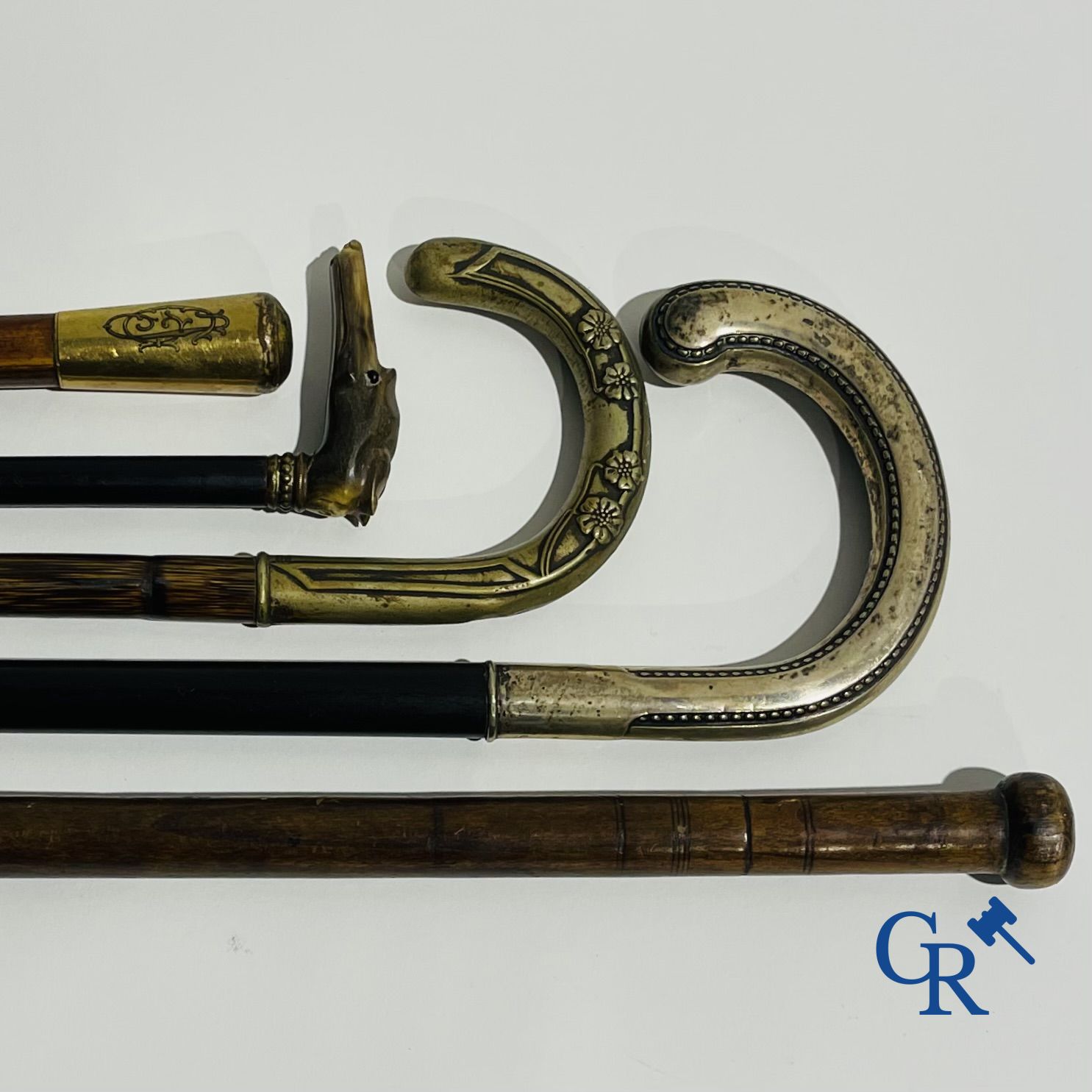 5 walking sticks including 1 with silver handle.