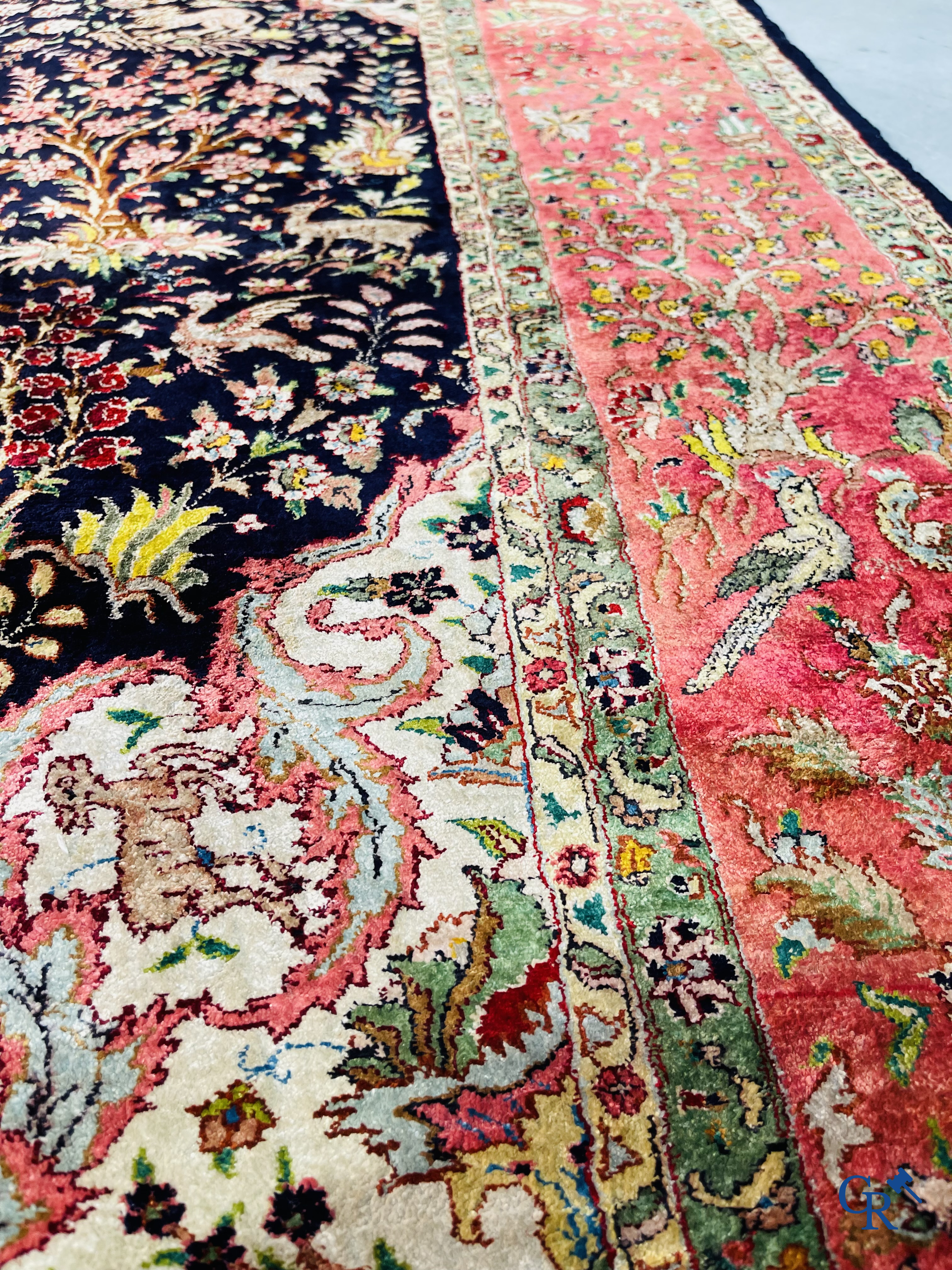 Oriental carpets: Tabriz, a finely hand-knotted silk carpet with forest animals and birds in a floral decor.