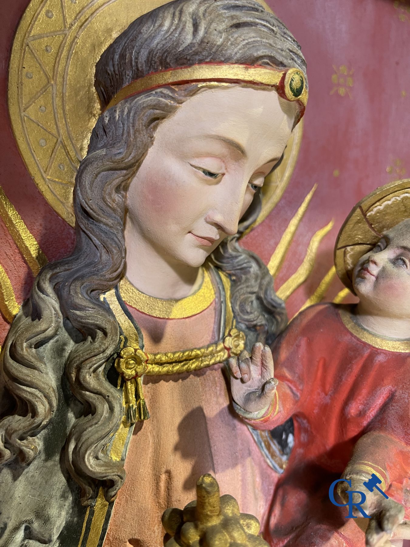 A 19th century wooden statue of Christ and a wooden display case with plaster representation of Mary with child.