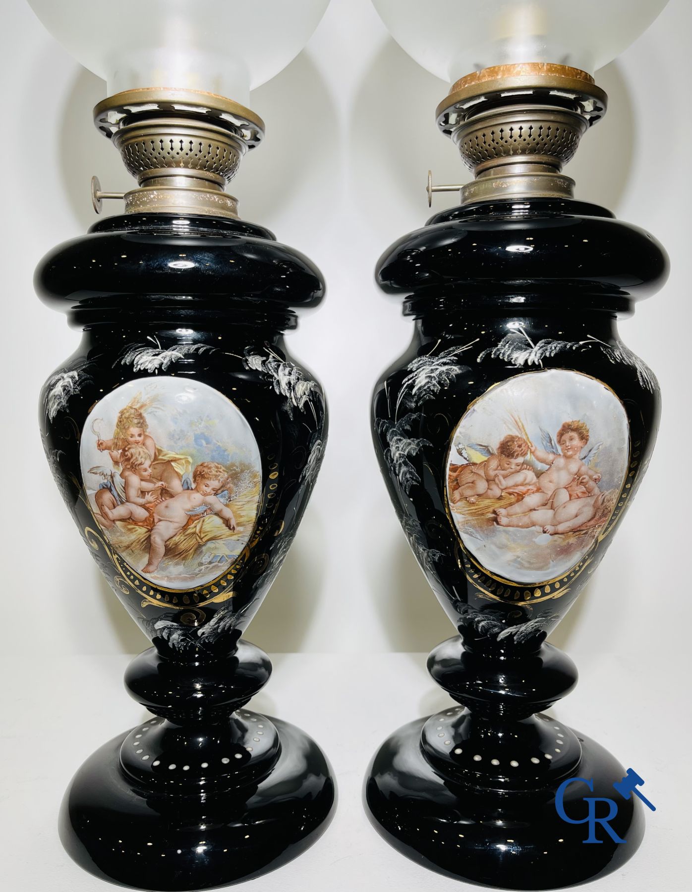 Pair of oil lamps in black opaline with enamelled decor.