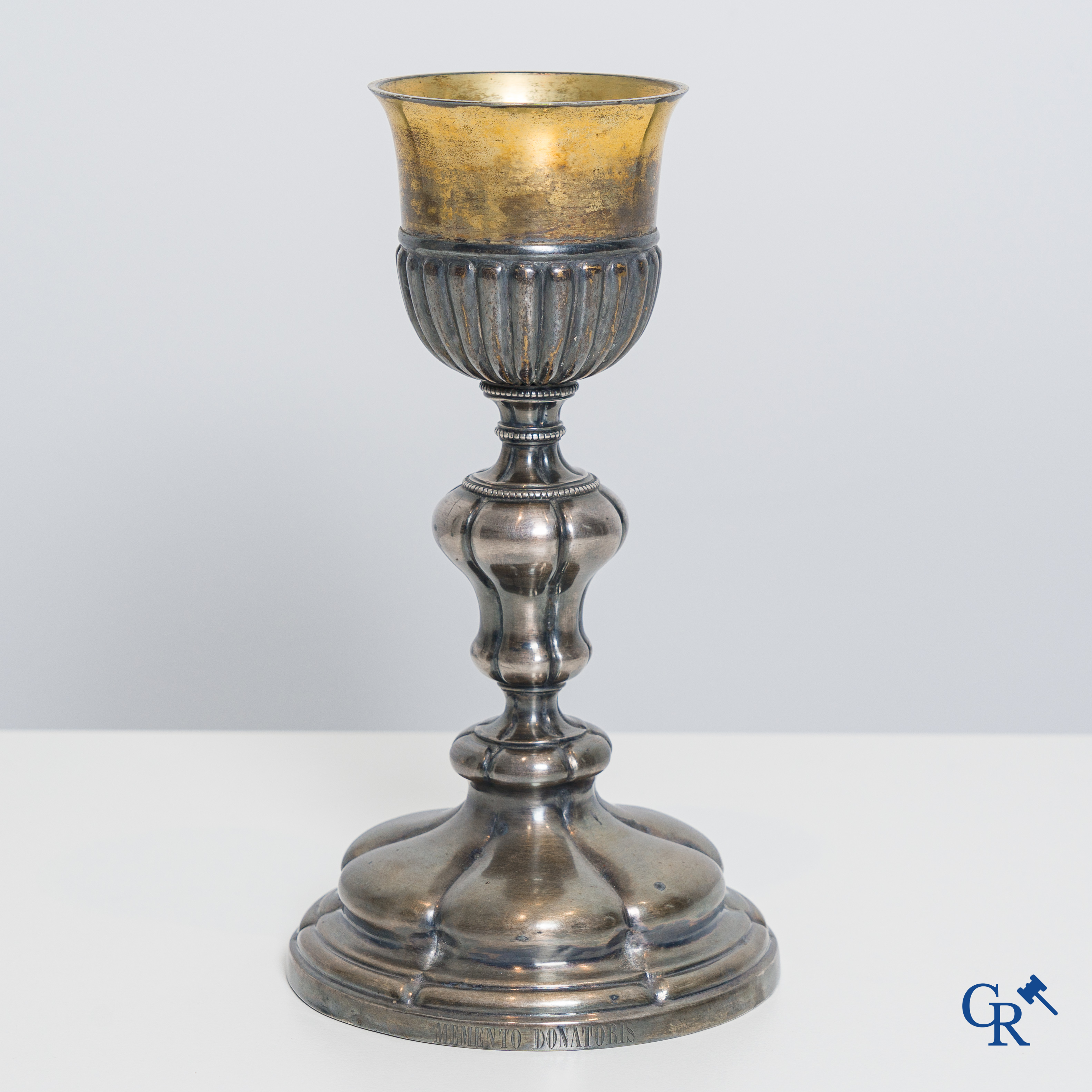 Religious objects. A silver- and gold plated chalice with Memento Donatoris inscriptions.