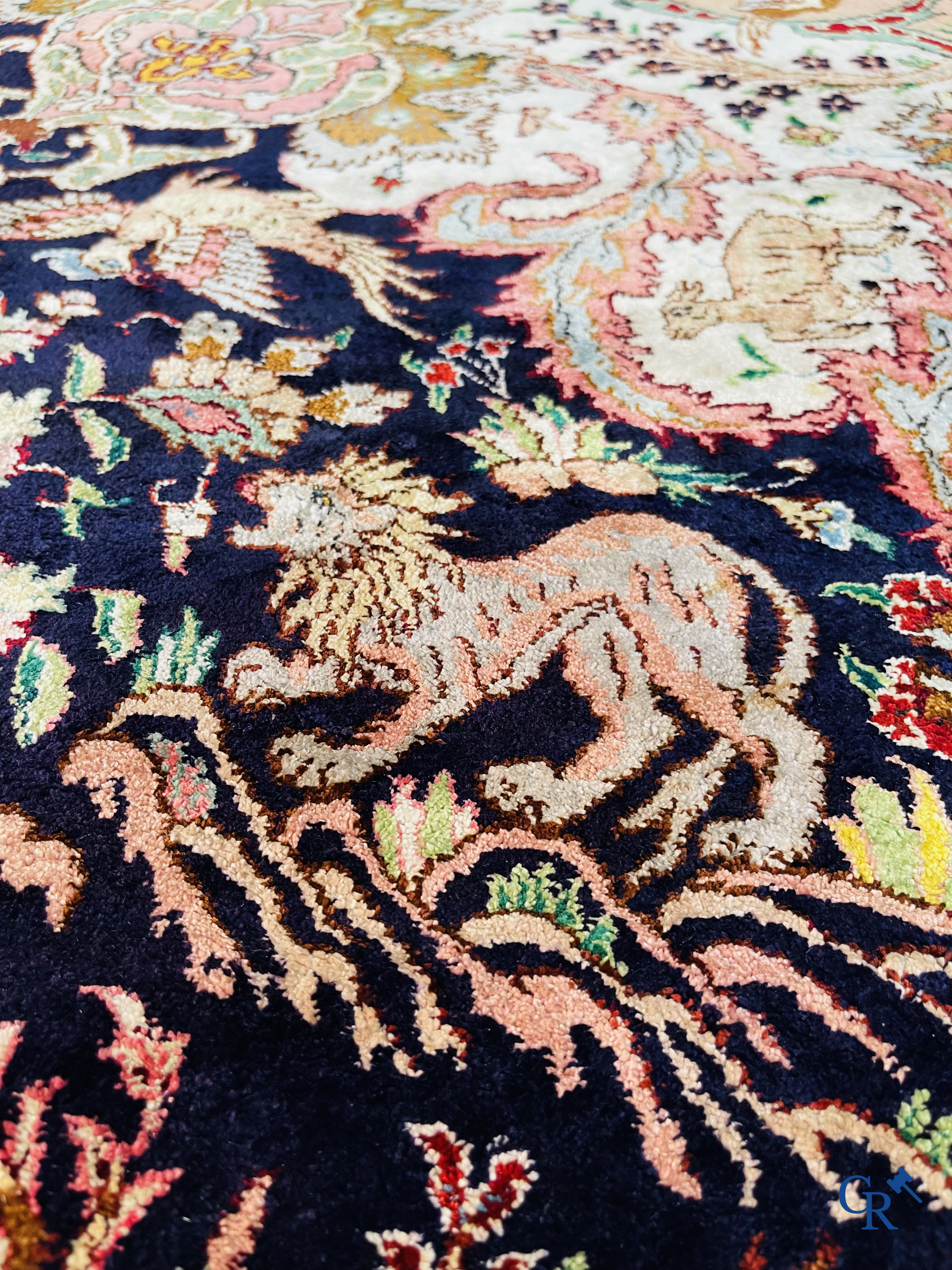 Oriental carpets: Tabriz, a finely hand-knotted silk carpet with forest animals and birds in a floral decor.