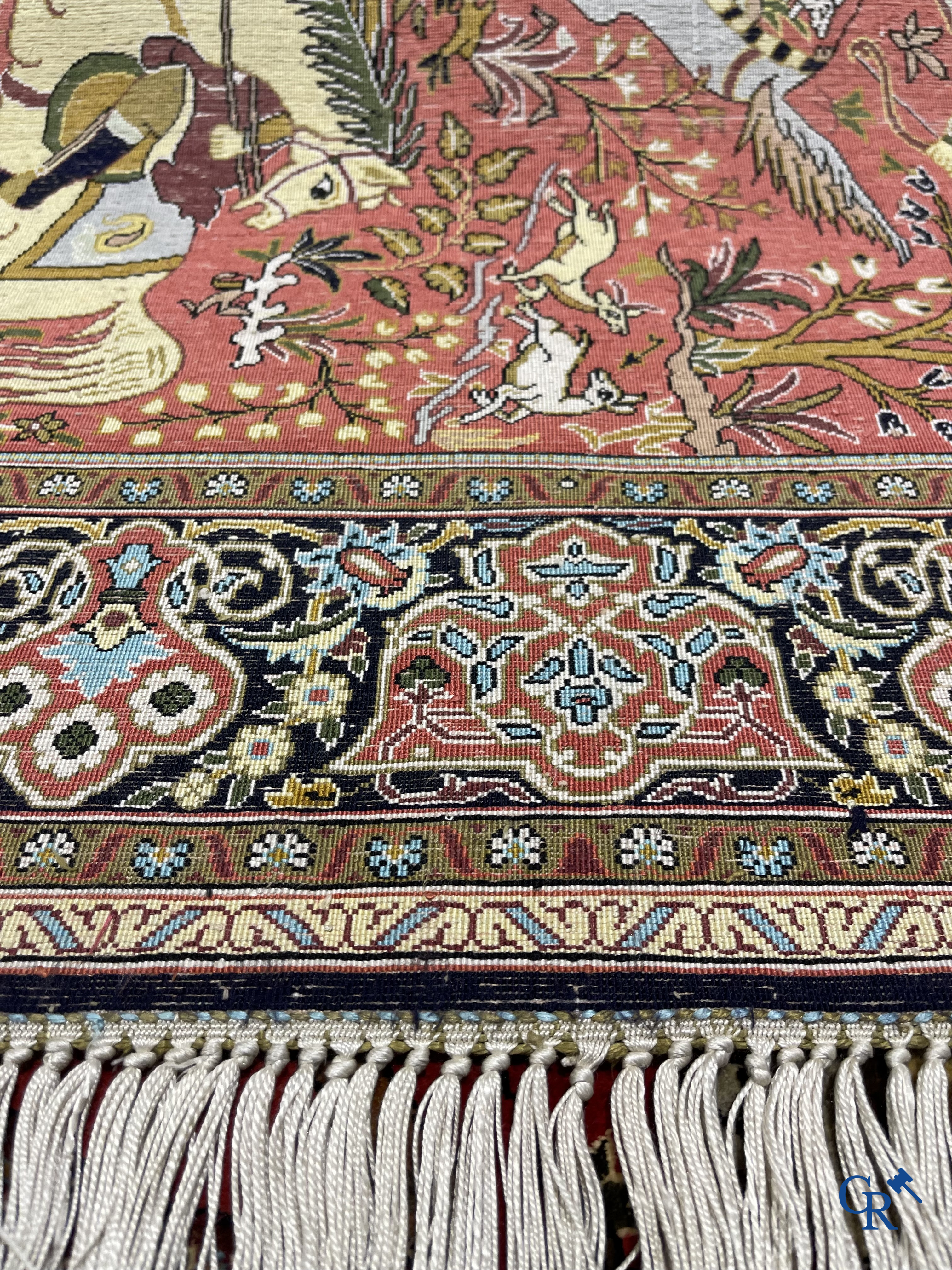 Oriental carpets, a Persian carpet in silk with a scene of hunters on horseback.