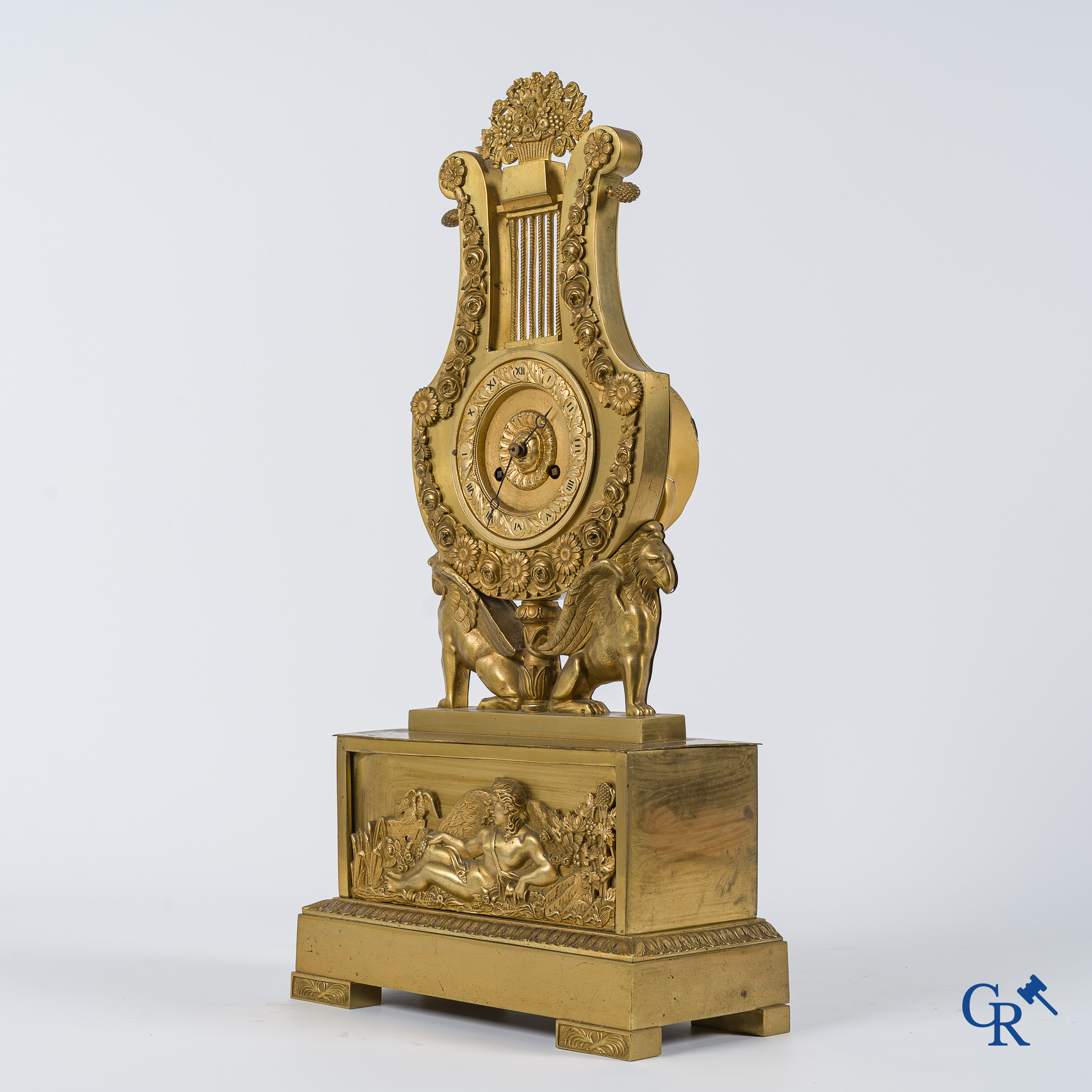 Charles X period. Beautiful pendulum in gilded bronze, a lyre held up by griffins. France, circa 1825.