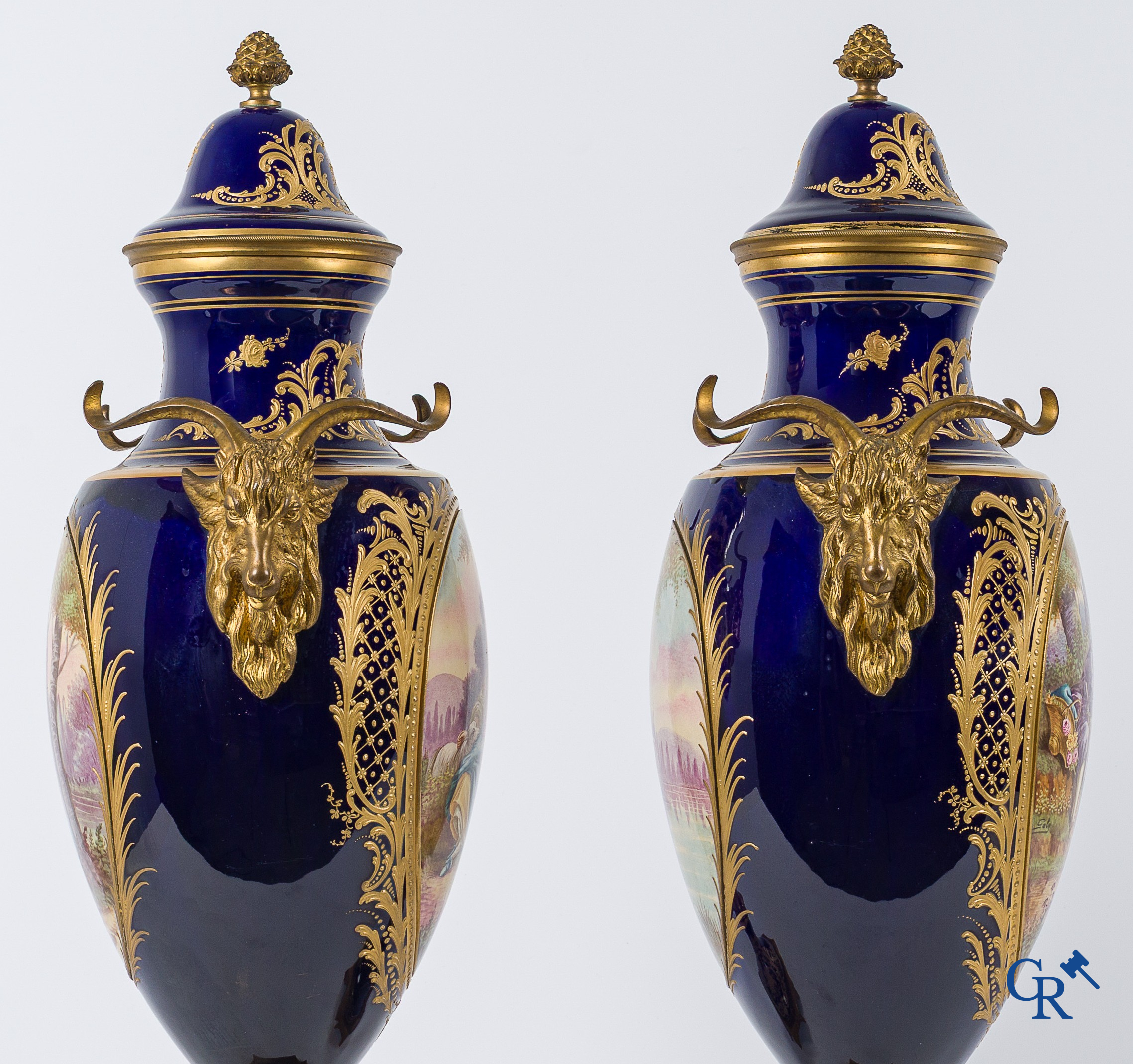 Sèvres. Pair of large decorated cobalt blue vases with bronze fittings and raised gilding. LXVI style. circa 1920.