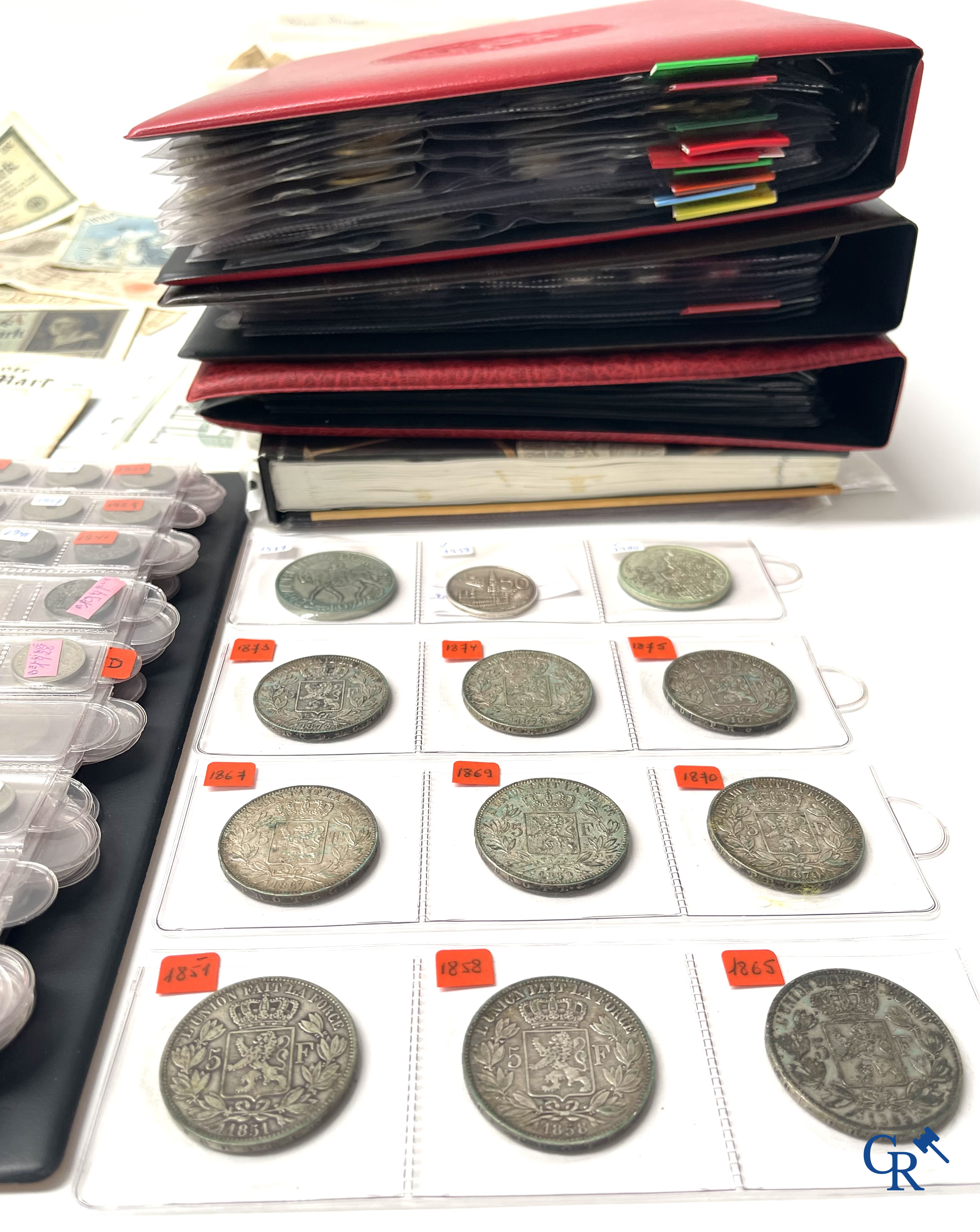 Old coins and banknotes. A large collection of old coins and banknotes. Multiple coins in silver.
