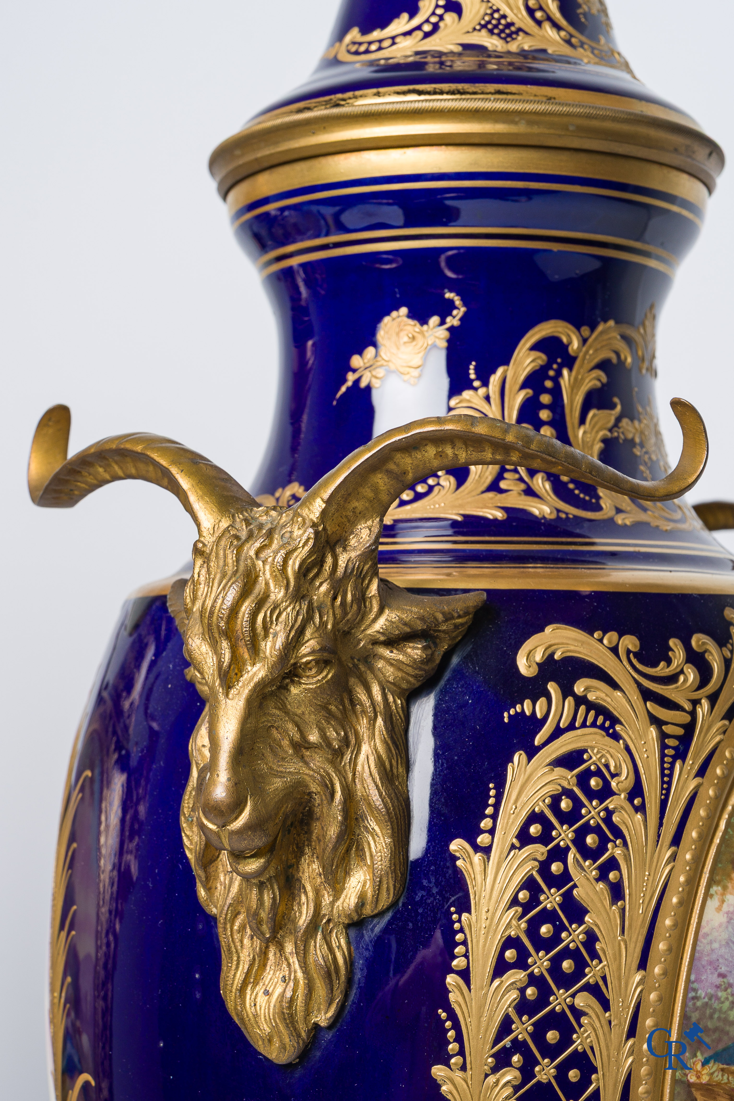 Sèvres. Pair of large decorated cobalt blue vases with bronze fittings and raised gilding. LXVI style. circa 1920.