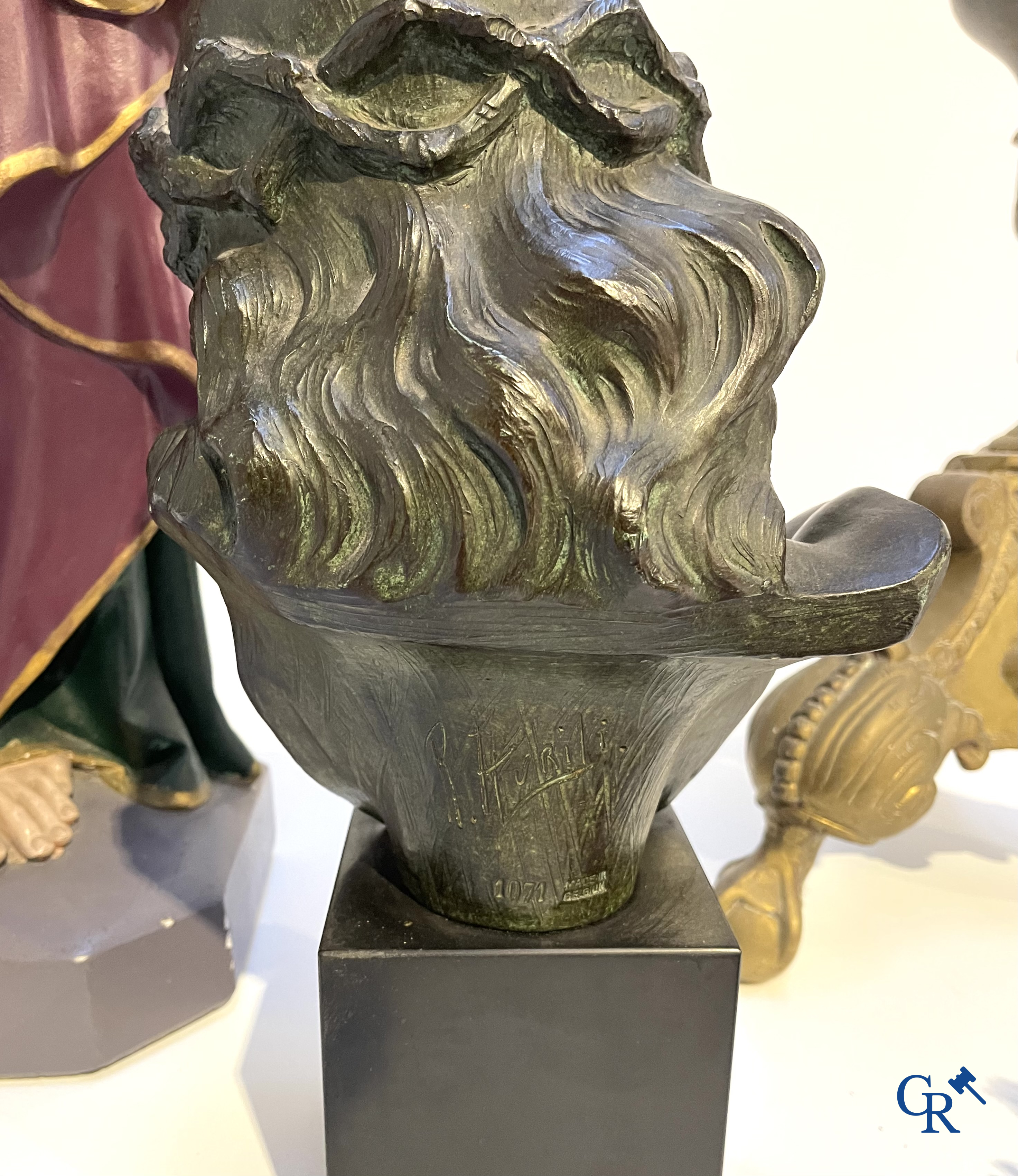 A large bronze candlestick, Saint Joseph with child in plaster, a terracotta bust of Christ and a holy water vessel.