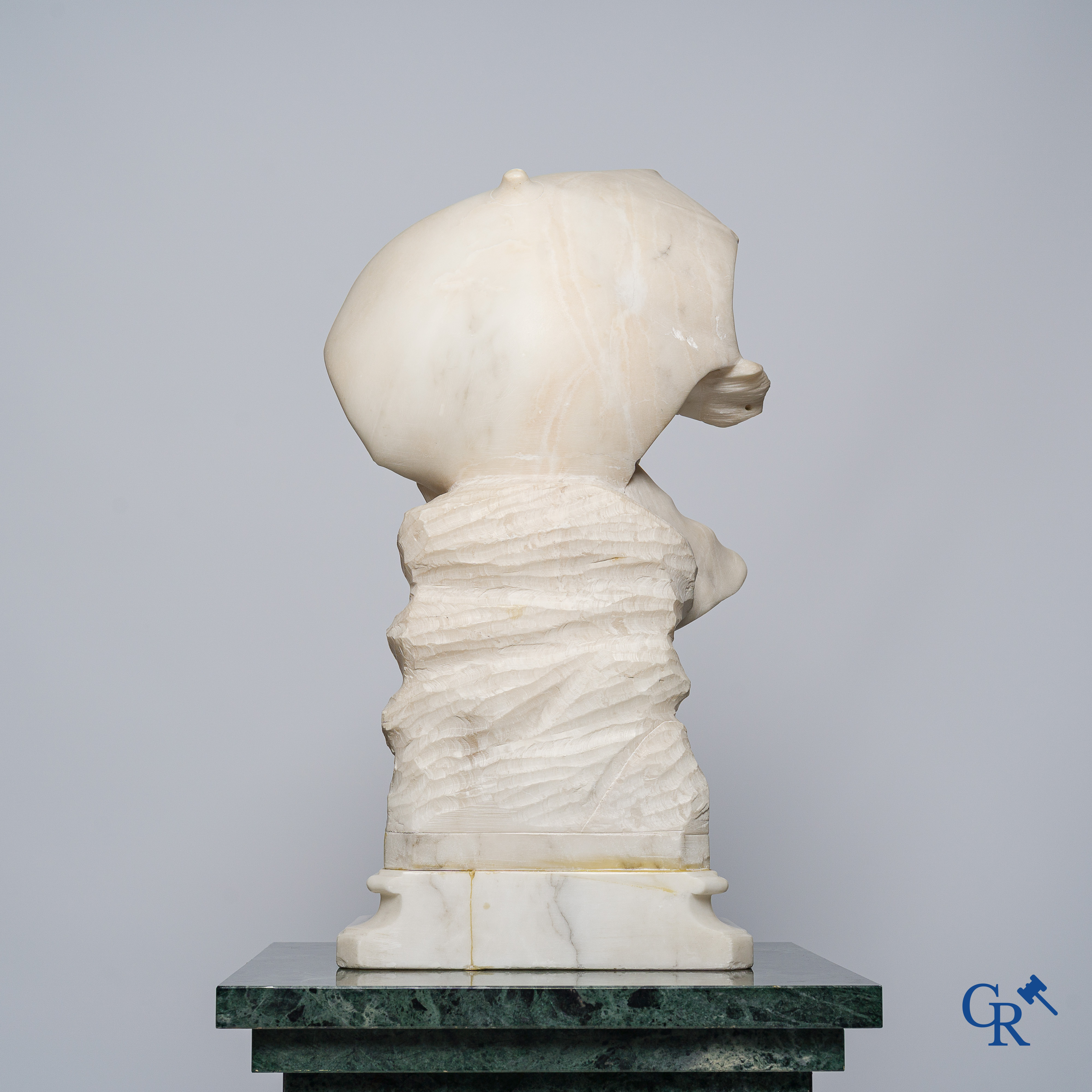 Amusing statue of a girl with umbrella in sculpted marble. No signature noticeable. Around 1920.